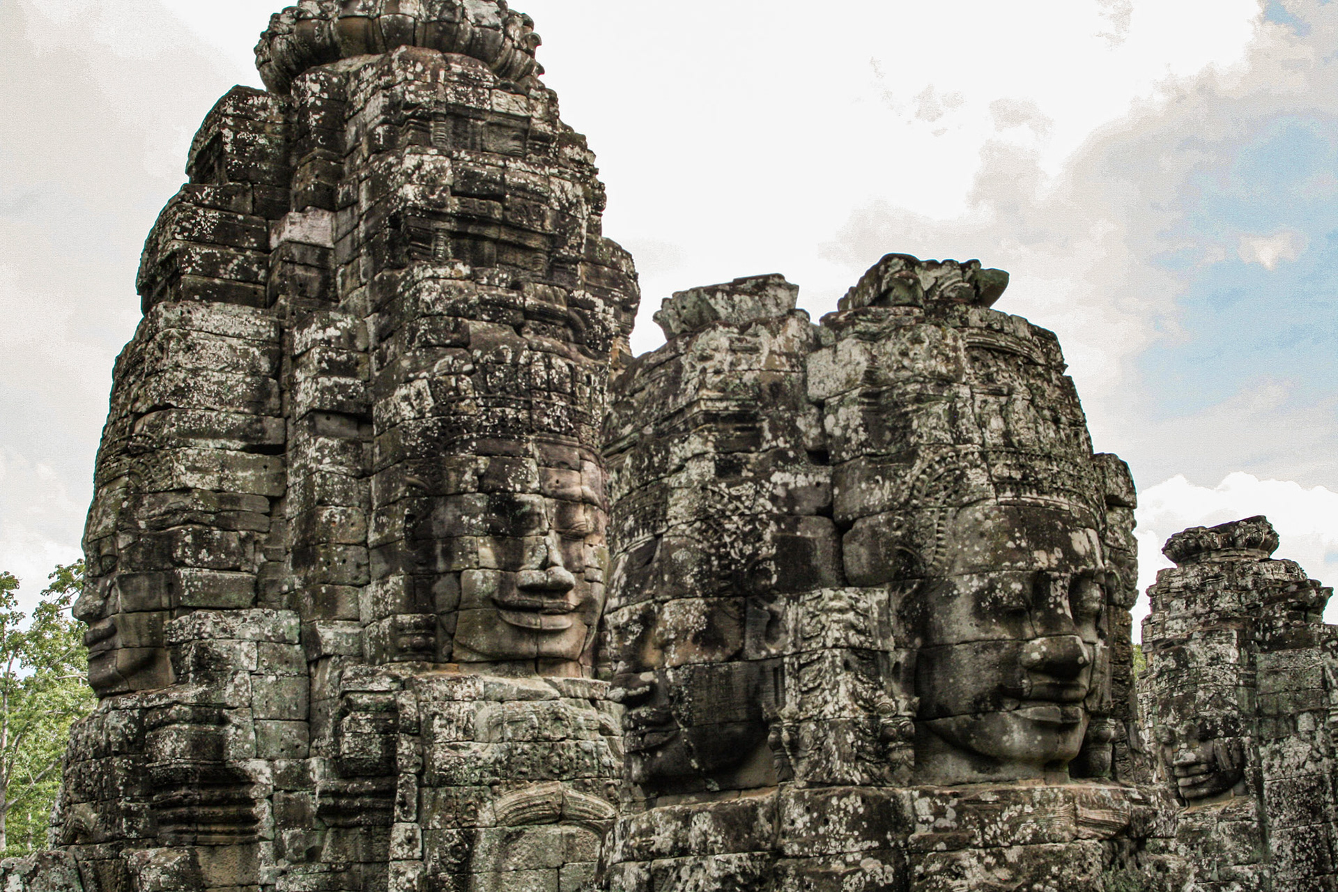 The Bayon's most distinctive feature is the multitude of serene and smiling stone faces on the many towers which jut out from the upper terrace and cluster around its central peak. 