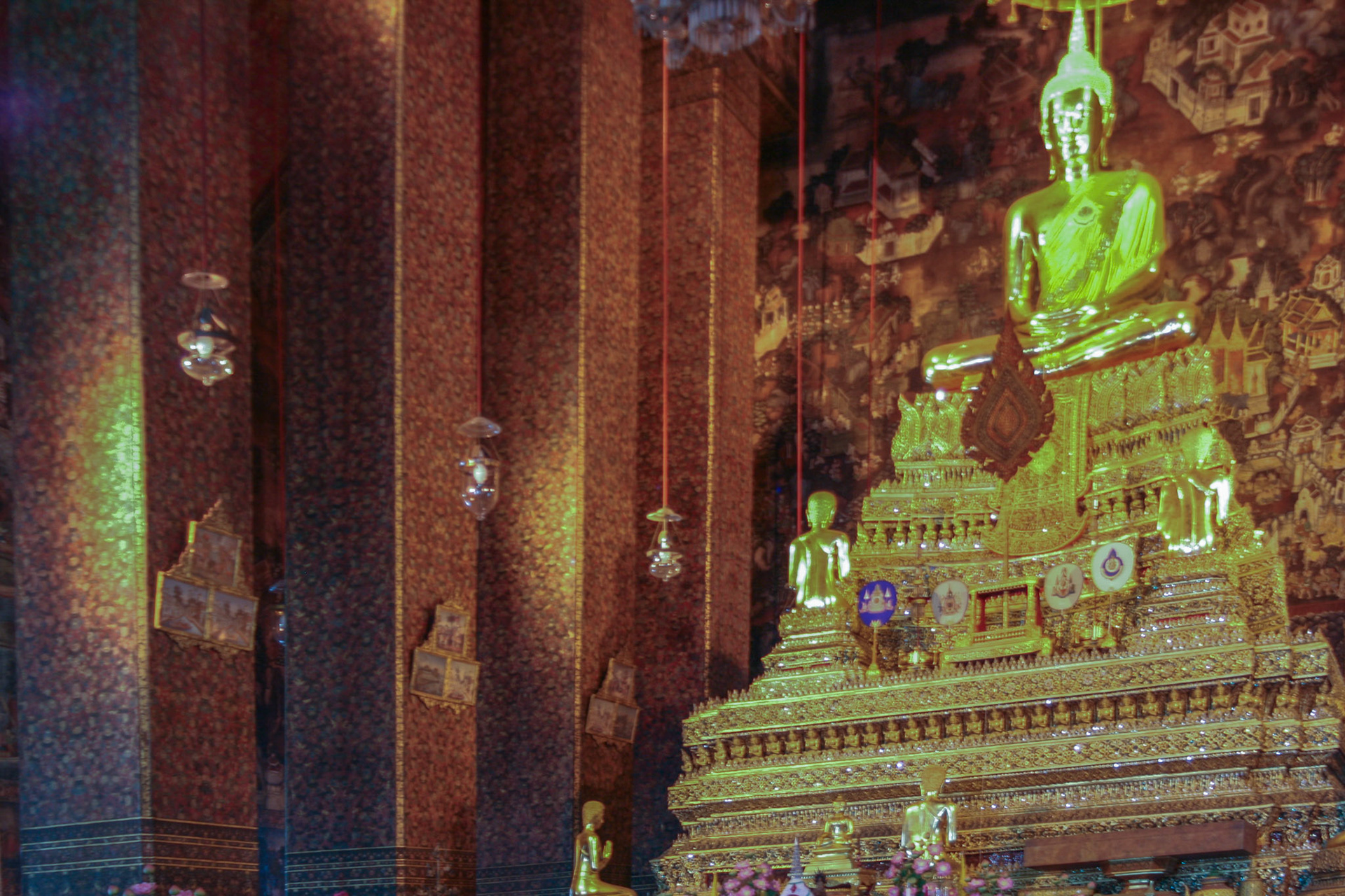 The Buddha in the ordination hall is the "Phra Buddha Deva Patimakorn" in a seated posture on a three tiered pedestal under which are some ashes of King Rama I.