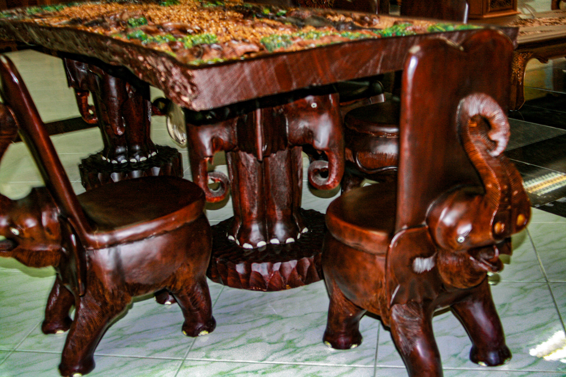 Wood carving on handmade furniture at a Teakwood art factory.