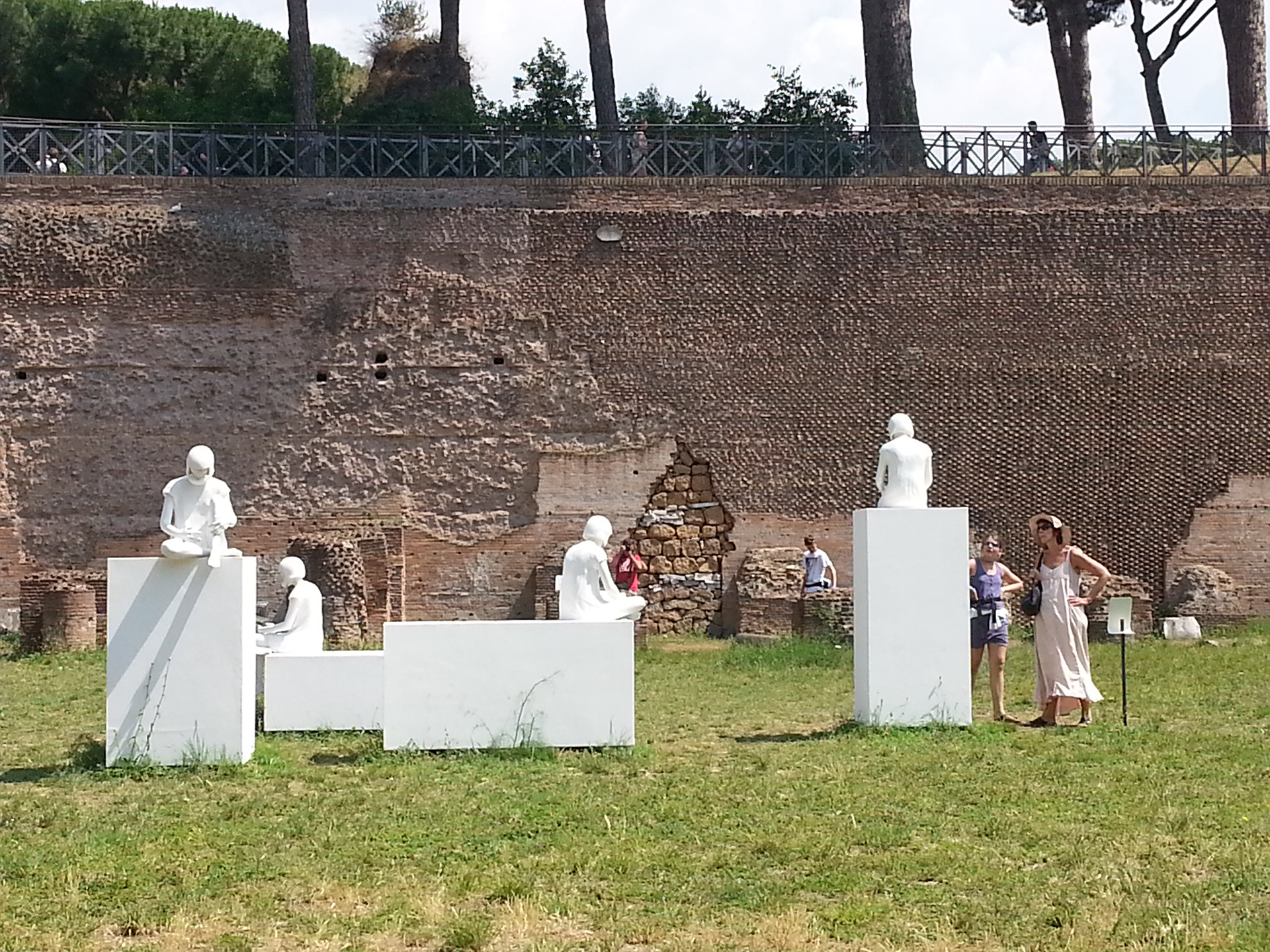 White statues sculpture of people sitting at the Stadium of Domitian at Palatine Hill in Rome. 