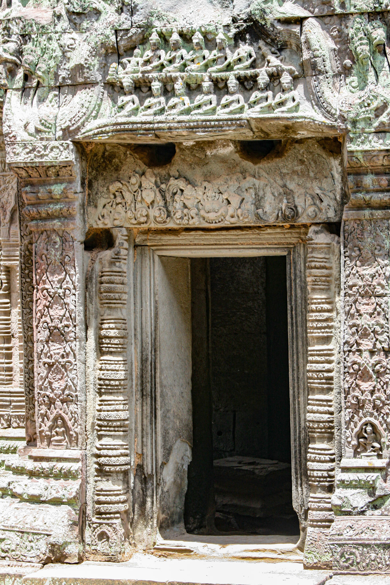 Bas relief above carved stone entrance at Ta Prohm temple.