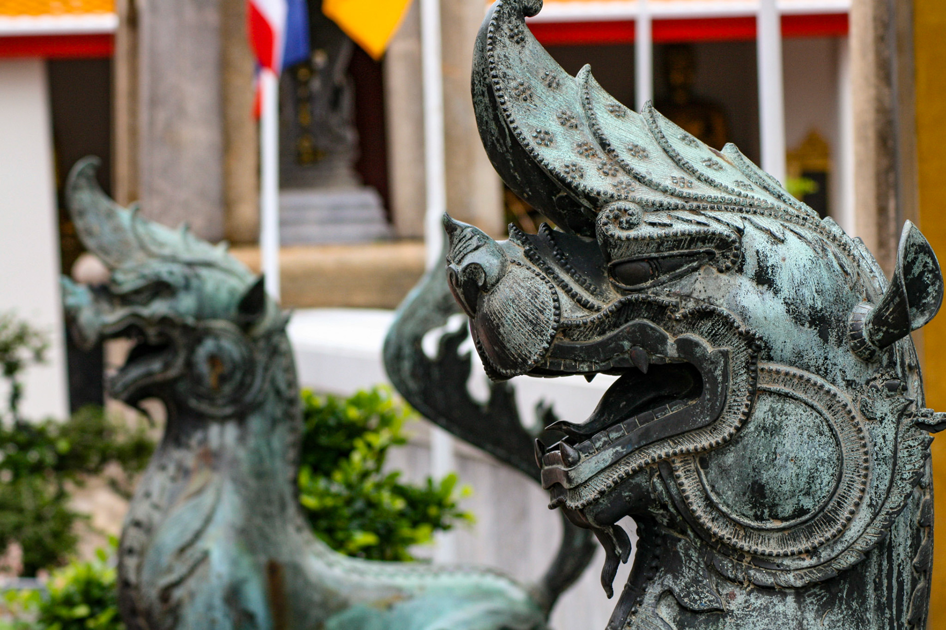 A bronze mythological lion guards the Ubosot