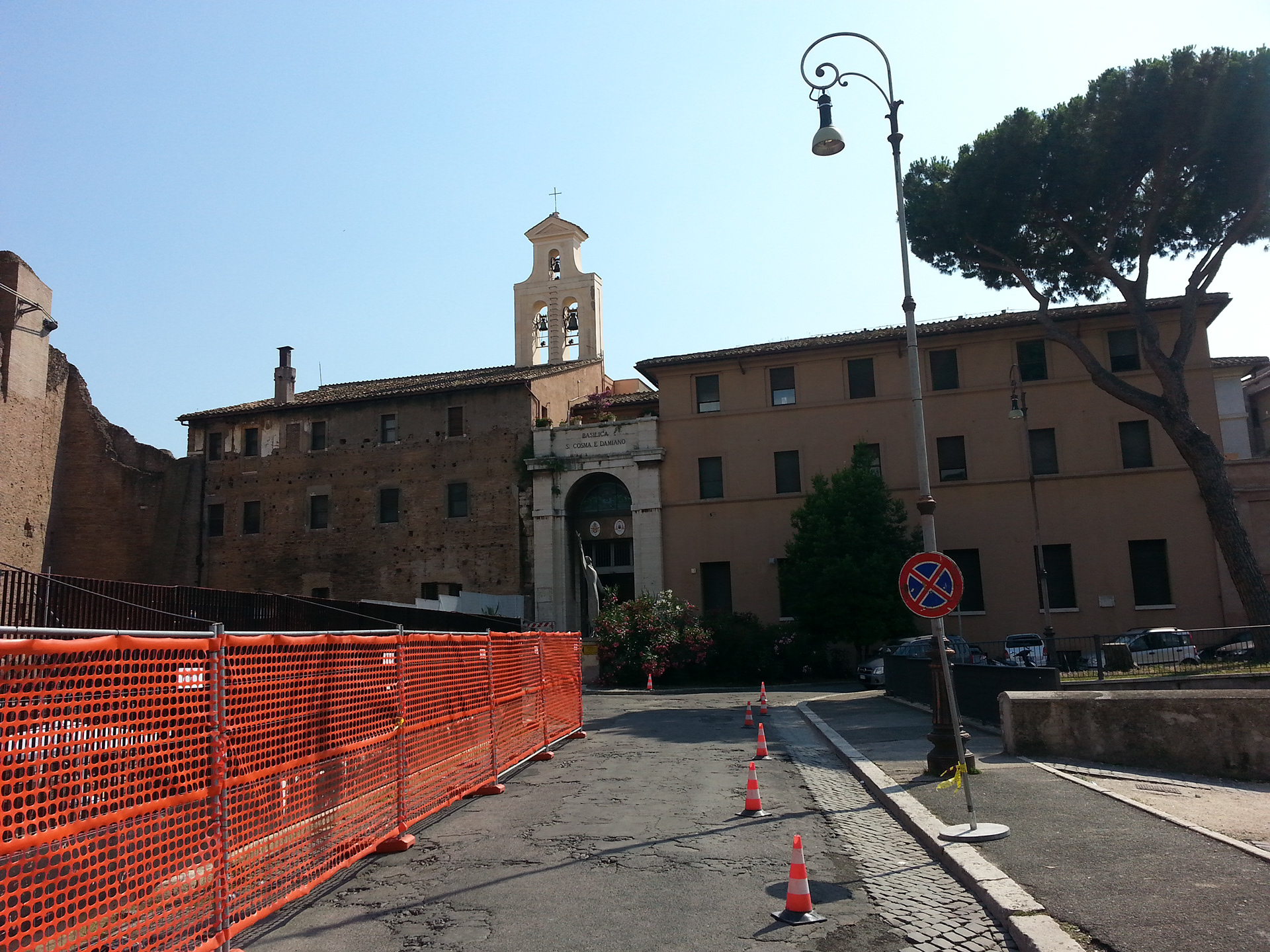 The basilica of Santi Cosma e Damiano is a titular church in Rome, Italy. The lower portion of the building is accessible through the Roman Forum and incorporates original Roman buildings, but the entrance to the upper level is outside the Forum. The circular building located at the entrance of the Forum, which now houses a small archeological exhibit, was built in the early 4th century as a Roman temple. It is thought to have been dedicated to Valerius Romulus, deified son of the emperor Maxentius. The main building was perhaps the library of an imperial forum. 