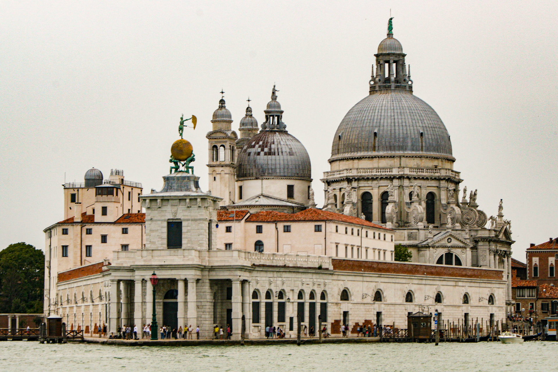 Basilica of Saint Mary of Health (1631-1687) on the Grand Canal and Customs Point. With its triangular shape, Punta della Dogana or the maritime custom warehouses splits the Grand Canal from the Giudecca Canal. 
