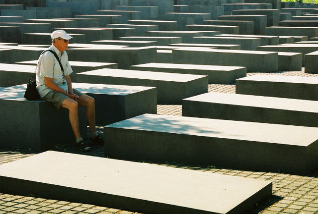 A visitor contemplates the Holocaust Memorial. 