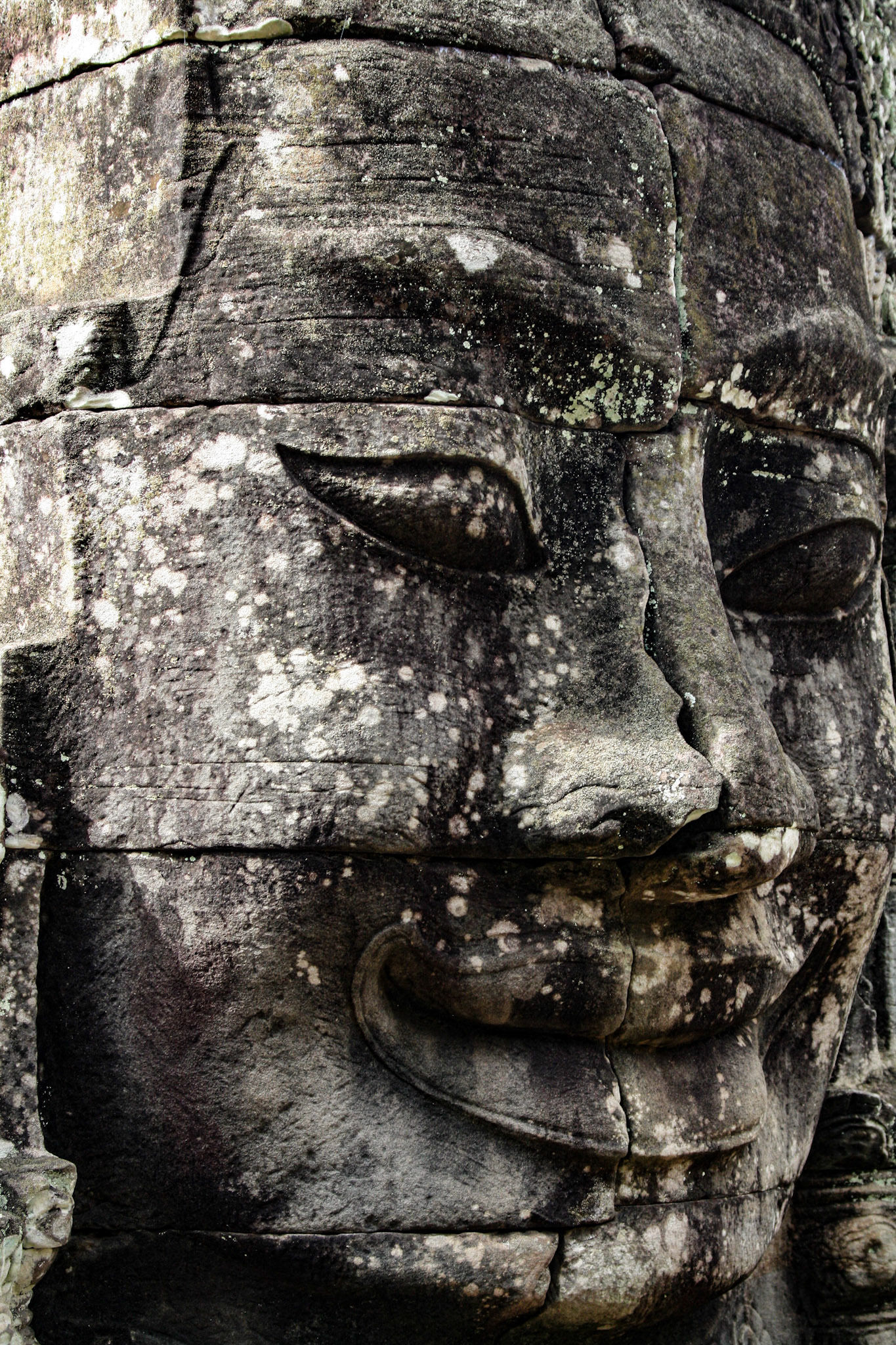 The Bayon's most distinctive feature is the multitude of serene and smiling stone faces on the many towers which jut out from the upper terrace and cluster around its central peak. 