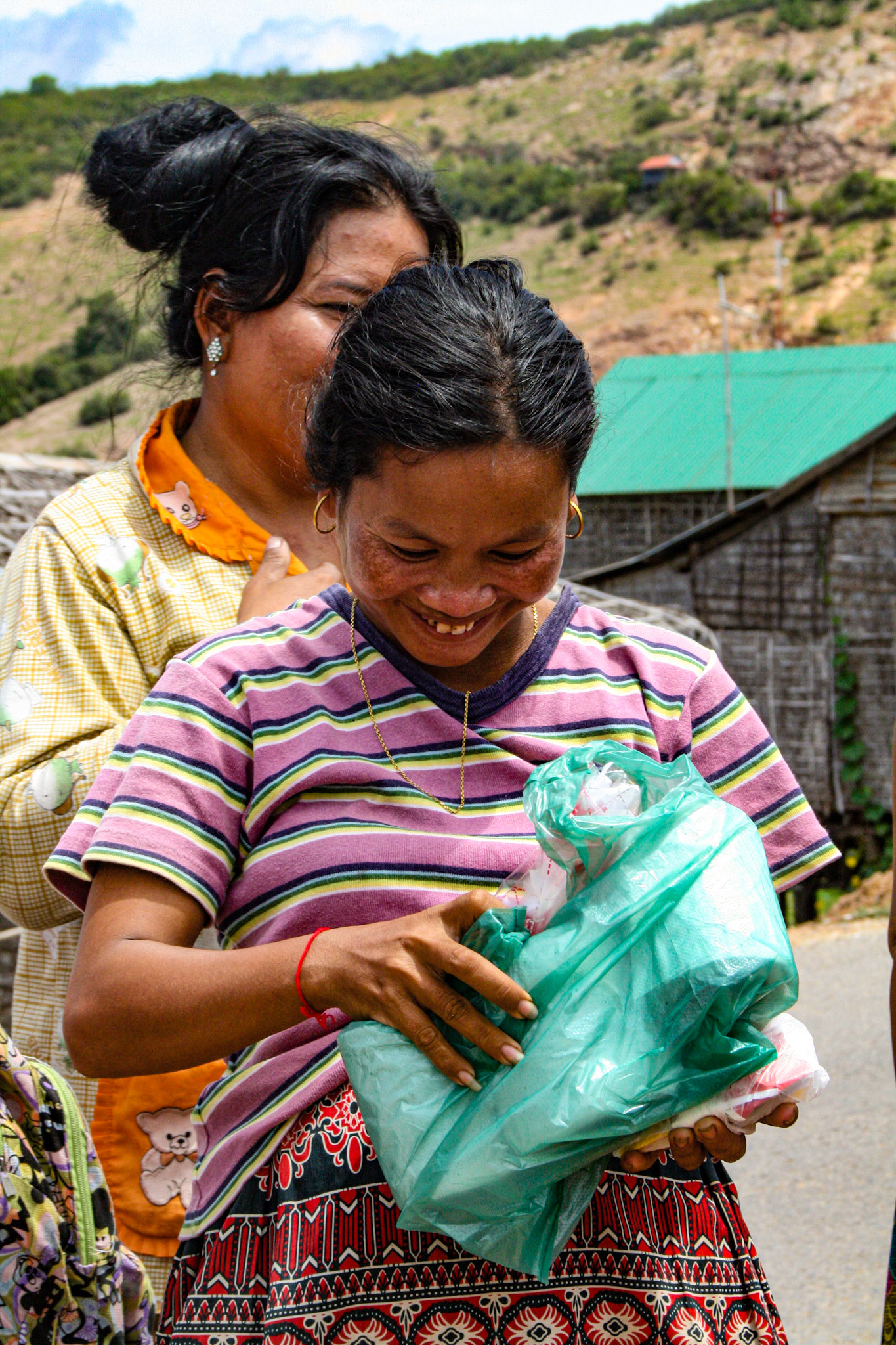 Our tour guide delivers varied and sundry gifts to some local villagers. Clothes, hygiene products, paper goods and other small items are among some of the items he collects for each time he visits. 