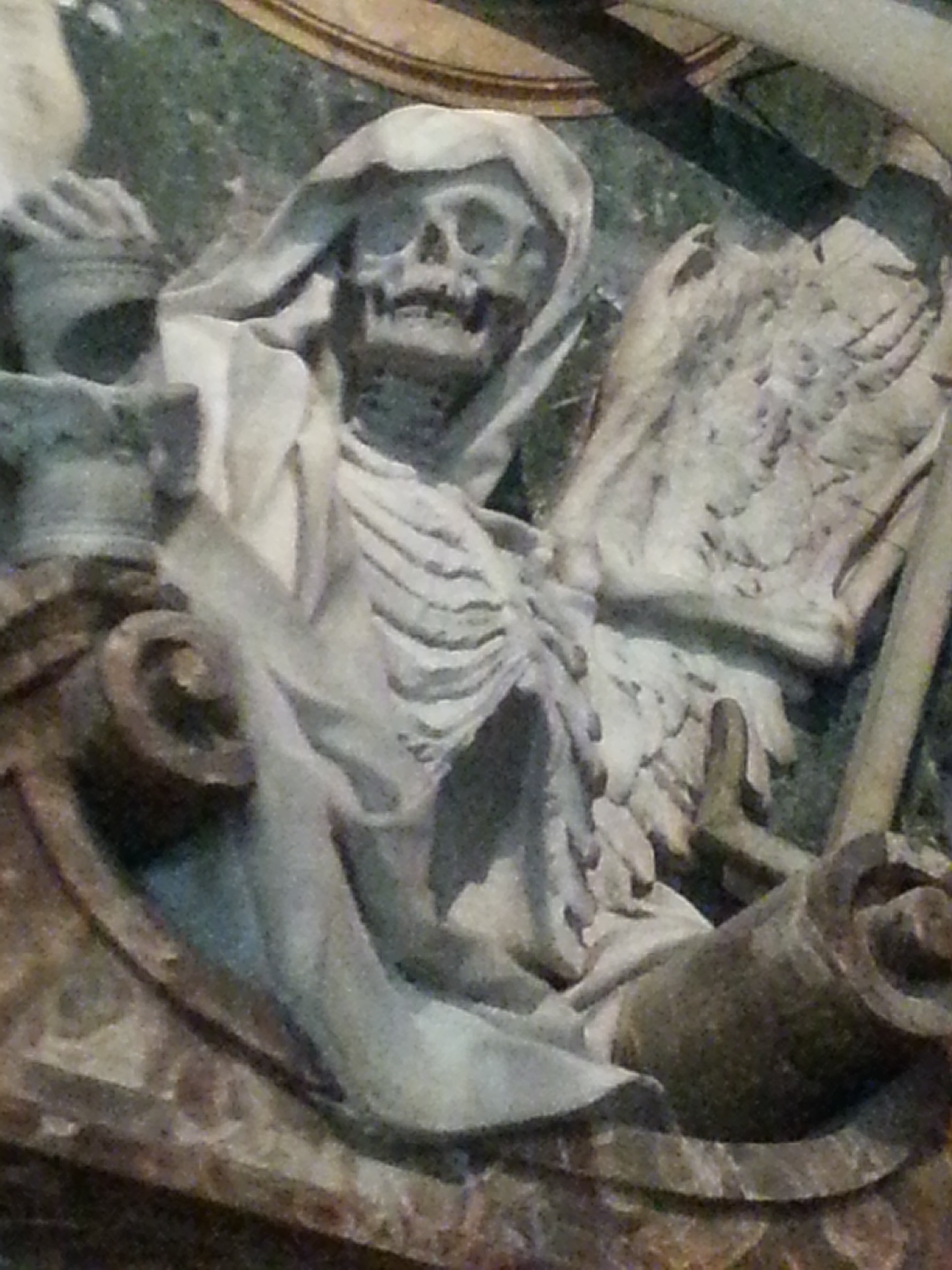 Tomb of Cardinal Cinzio Aldobrandini at Pietro in Vincoli in Rome, Italy. The marble frieze includes a grim reaper and human skeletons. 