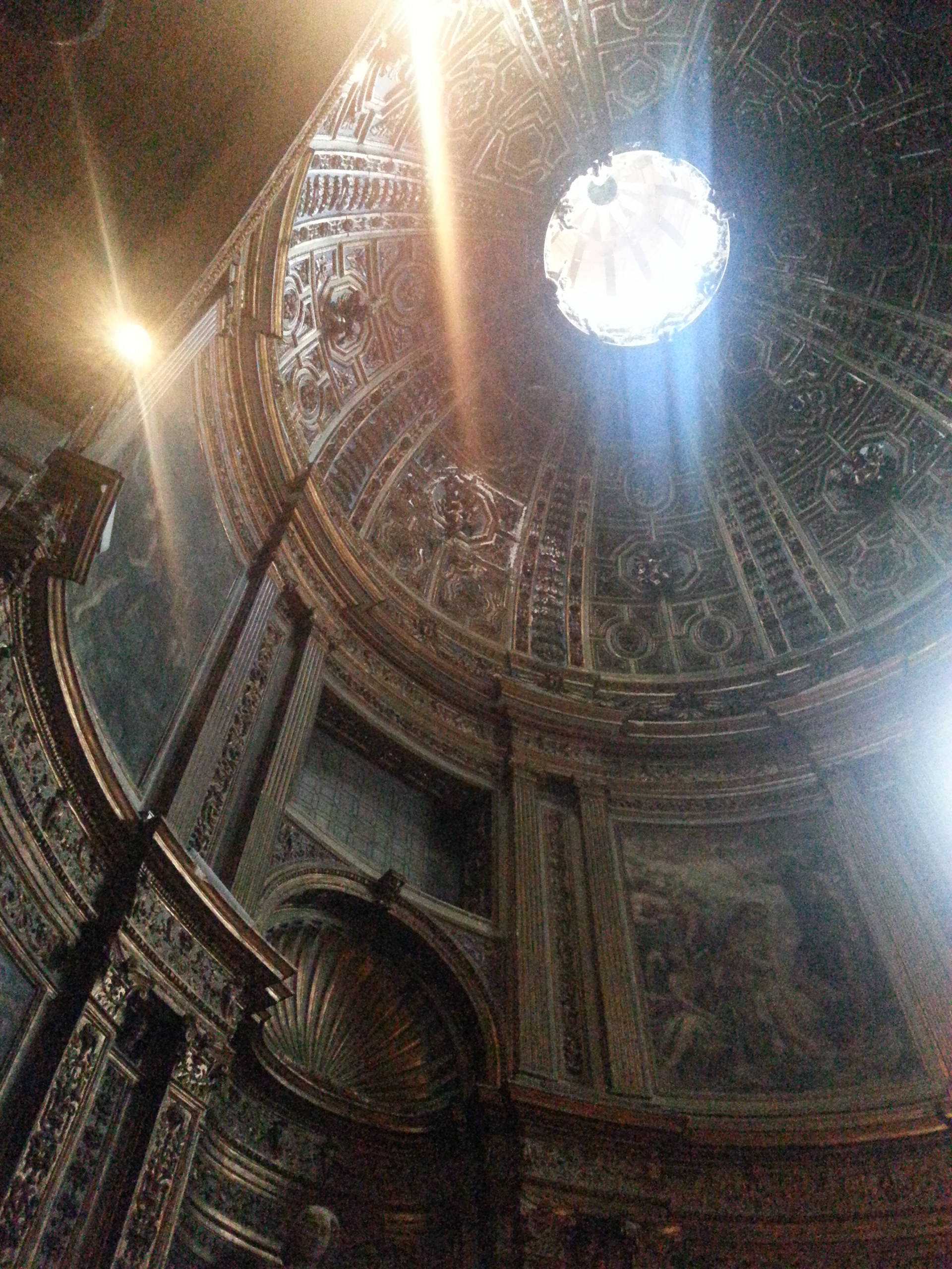 The gilded stucco dome of the Chapel of St. John the Baptist in the North (left) transept.