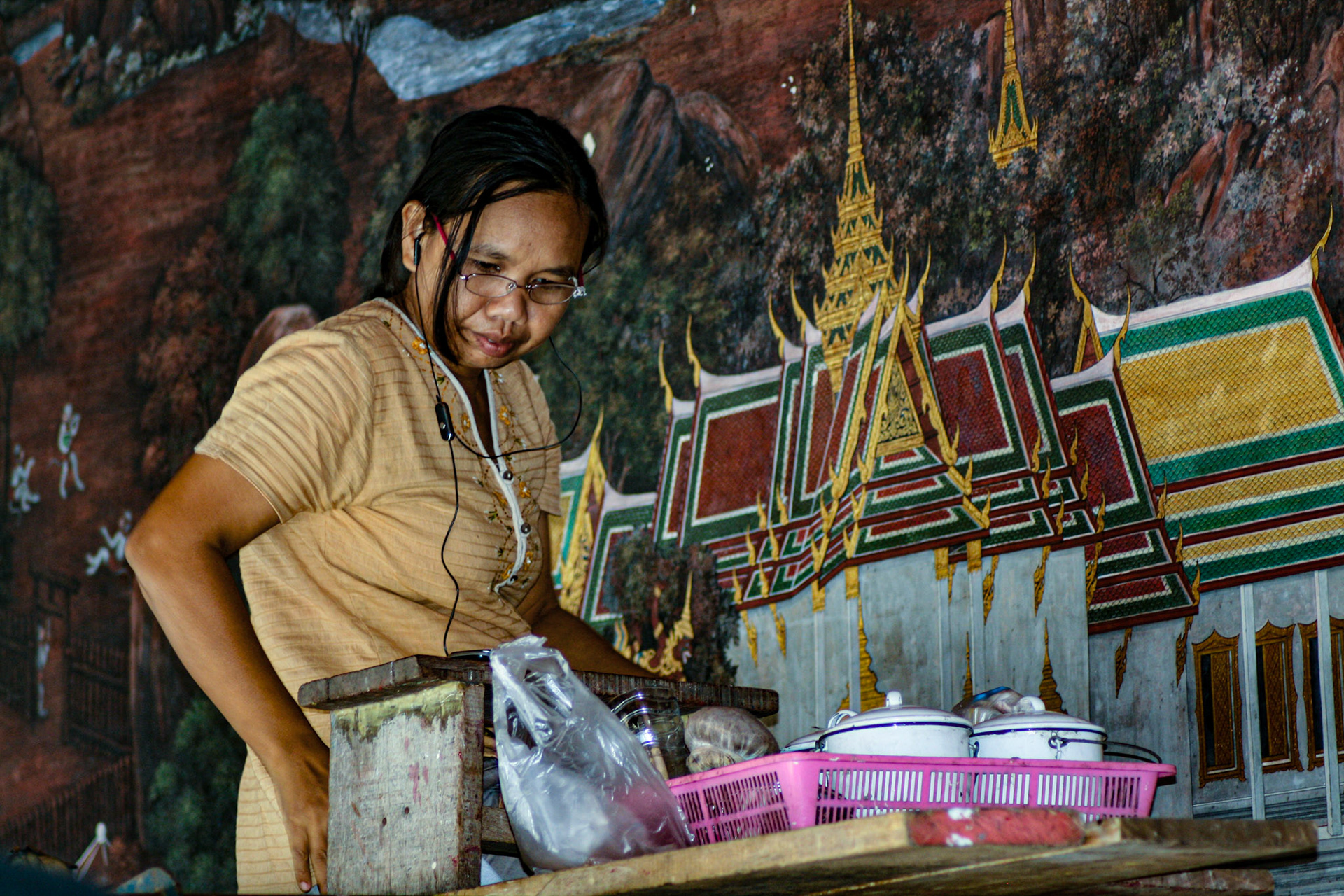 Artist spruces up wall mural.