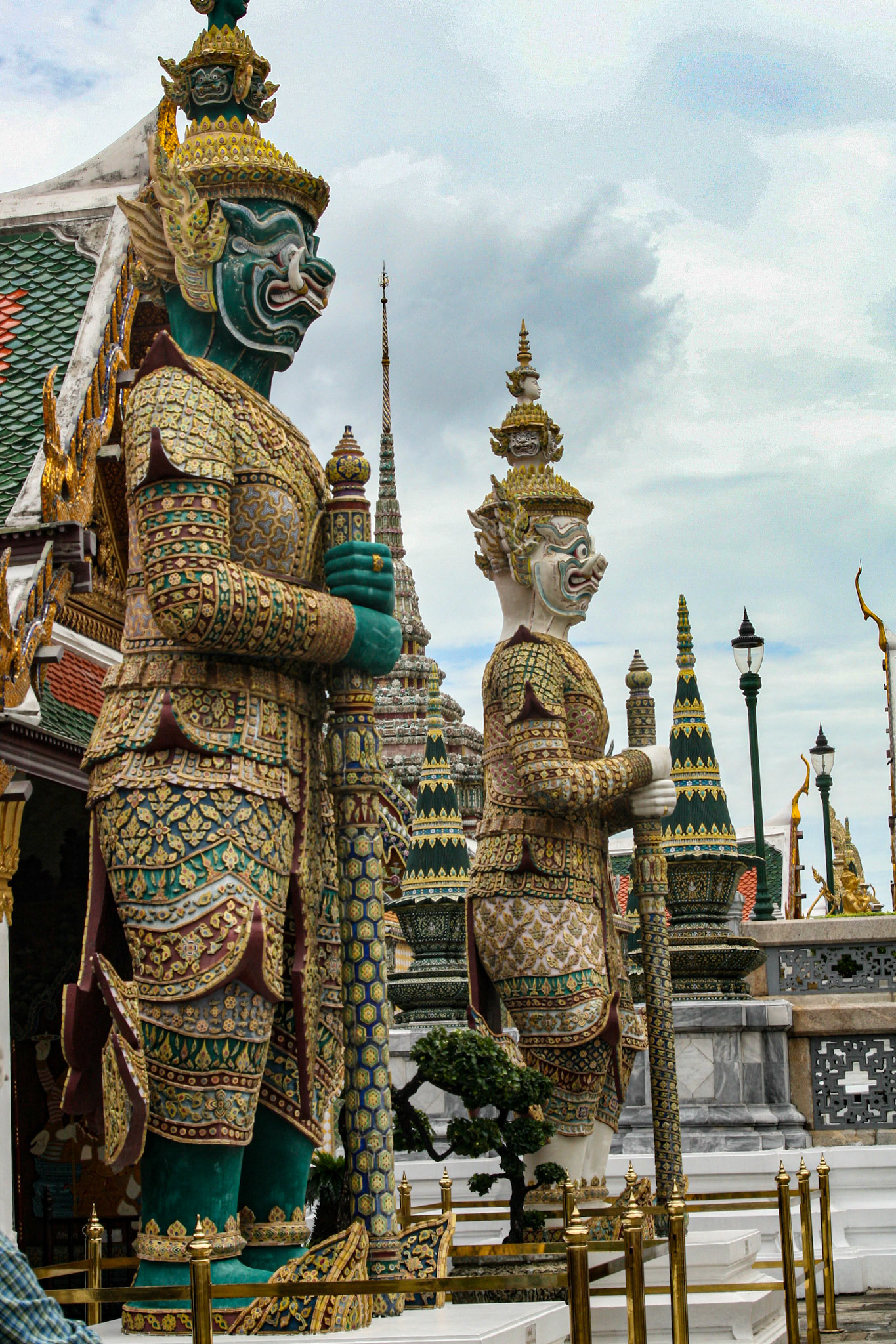 Six pairs of giant demon guardians flank all entrances to the Temple of the Emerald Buddha in Bangkok, Thailand. They are known as yaksha or in Thai are simply called yak (giant) and they are Buddhist gods that protect against evil spirits. The yaksha were placed there during the reign of Rama III. 