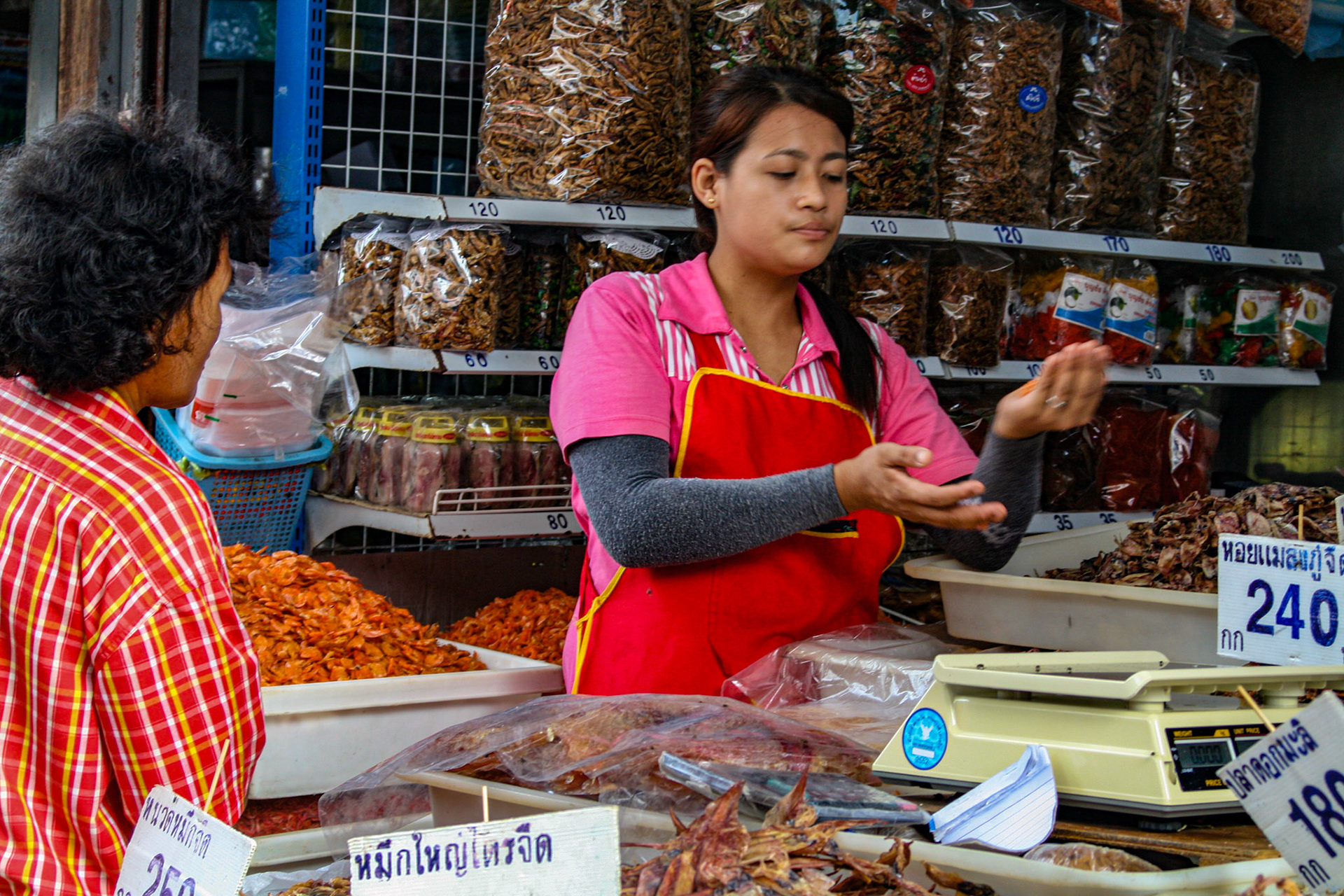 Shoppers make their way through and around the various vendors picking up whatever is needed for the day. 