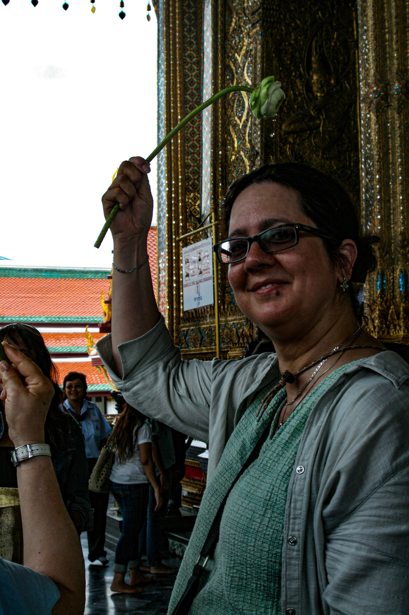 Linda Bathgate seeks the benefits of the sacred waters in Bangkok, Wat Phra Kaew.