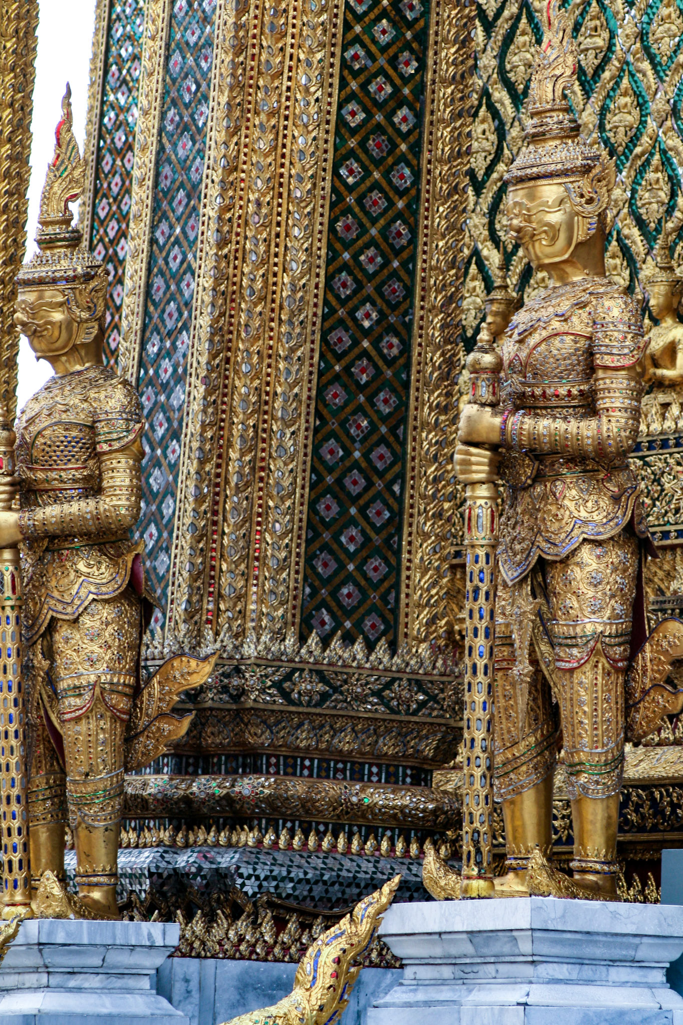 A pair of golden Yaksha steadfastly guards the entrance to Phra Mondop at the Temple of the Emerald Buddha. This royal library at the Grand Palace is never opened to the public because inside are the holy scriptures called the Tripitaka or Triple Basket. They are considered to be too sacred. Phra Mondop means the library of palm-leaf scriptures. 