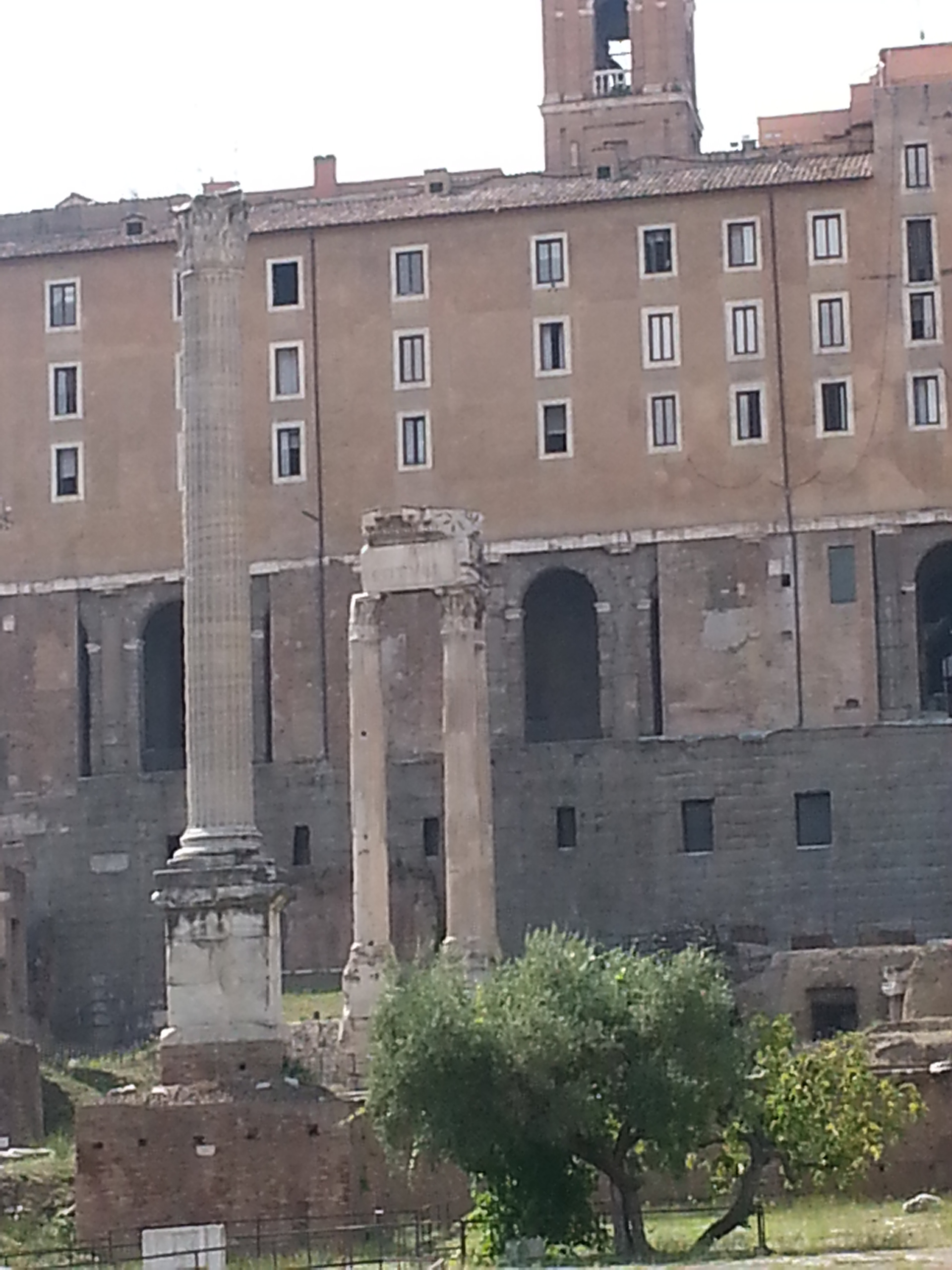 The Tabularium, behind the corner columns of the Temple of Vespasian and Titus. 