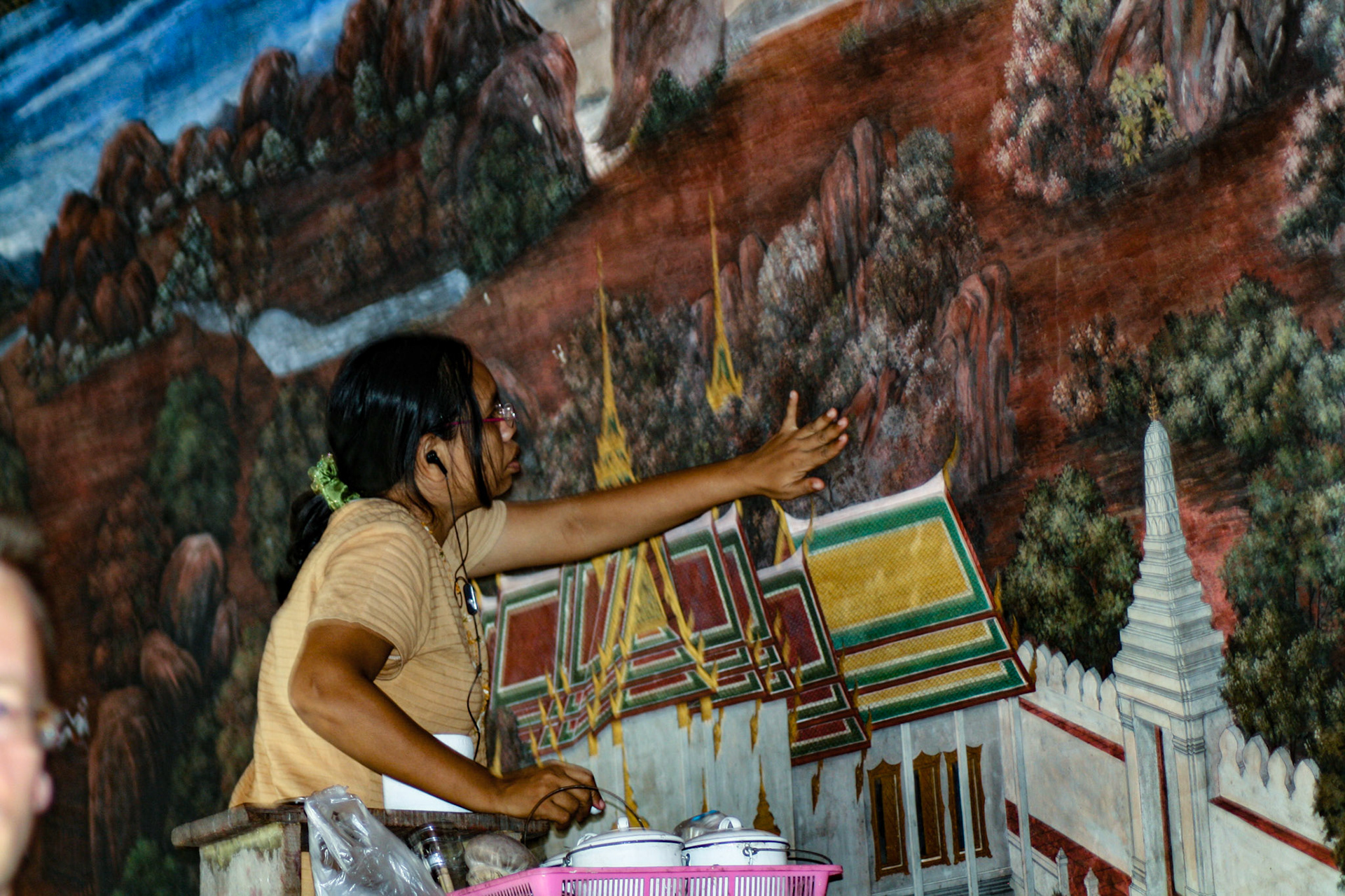 Artist spruces up wall mural.