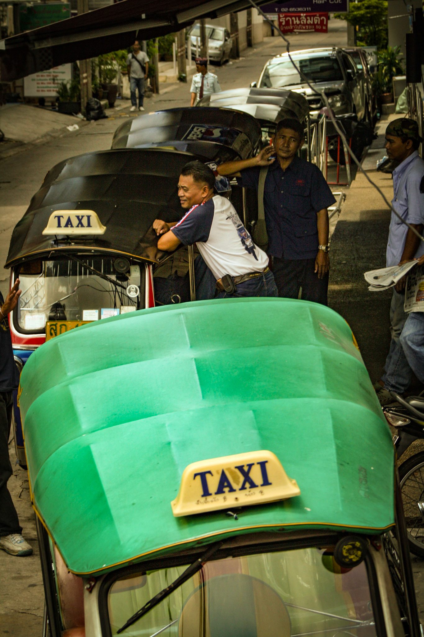 Tuk-Tuk taxicab drivers await the next fare. The cabs are nicknamed after the supposed sound they make as they travel down the street.