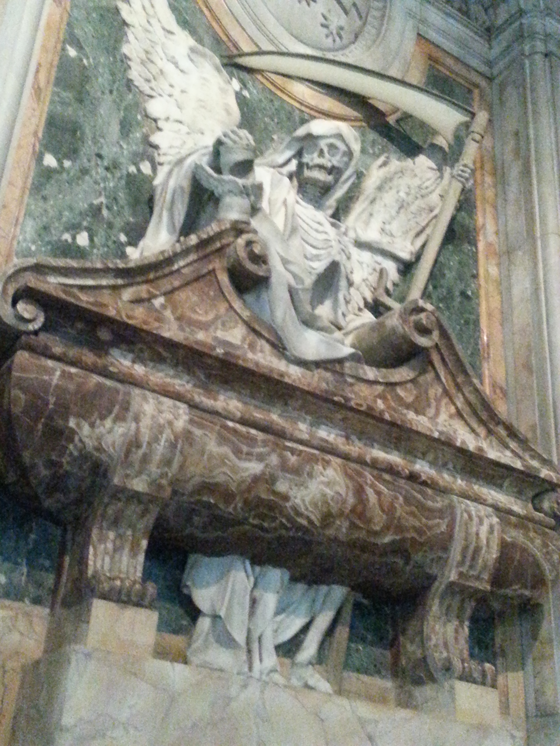 Tomb of Cardinal Cinzio Aldobrandini at Pietro in Vincoli in Rome, Italy. The marble frieze includes a grim reaper and human skeletons. 