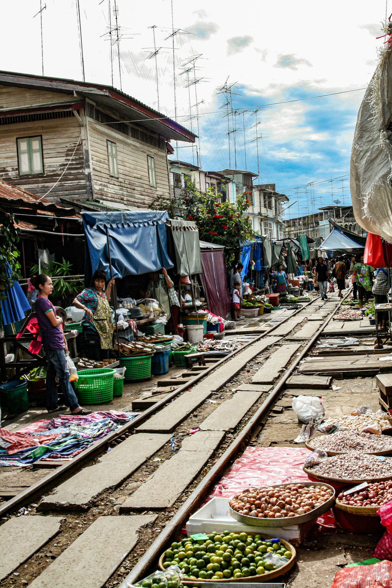 One minute you see the locals shopping for their vegetables and the next, vendors scoop up their baskets and boxes and anything that lies over the track.