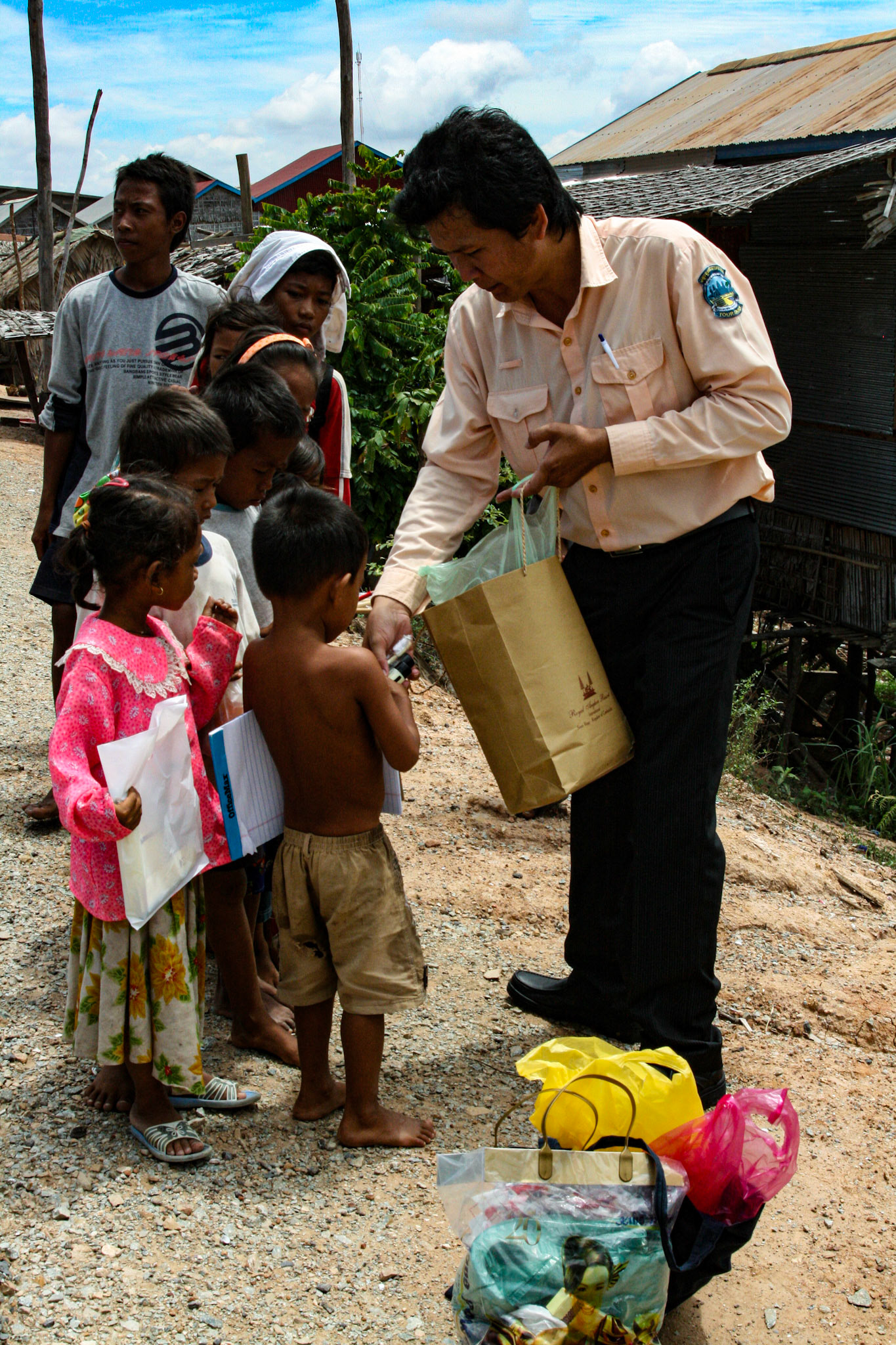 Our tour guide delivers varied and sundry gifts to some local villagers. Clothes, hygiene products, paper goods and other small items are among some of the items he collects for each time he visits. 