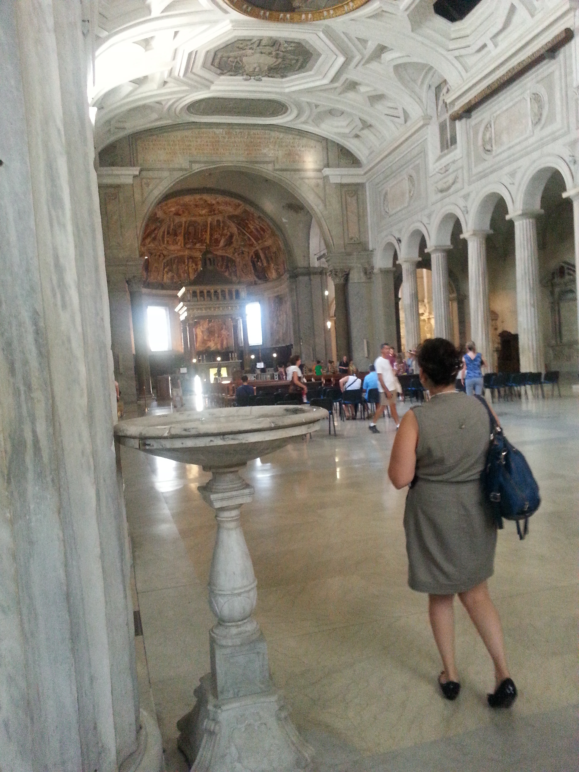 San Pietro in Vincoli (Saint Peter in Chains) interior has a nave and two aisles, with three apses divided by antique Doric columns. The aisles are surmounted by cross-vaults, while the nave has an 18th-century coffered ceiling, frescoed in the center by Giovanni Battista Parodi, portraying the Miracle of the Chains (1706). In this scene, Pope Alexander heals the neck goiter of Saint Balbina by touching her with the chains that once bound St Peter. 