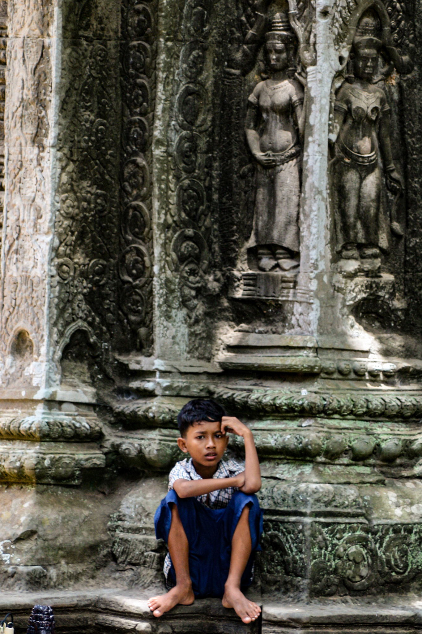 A local boy watches the world go by.