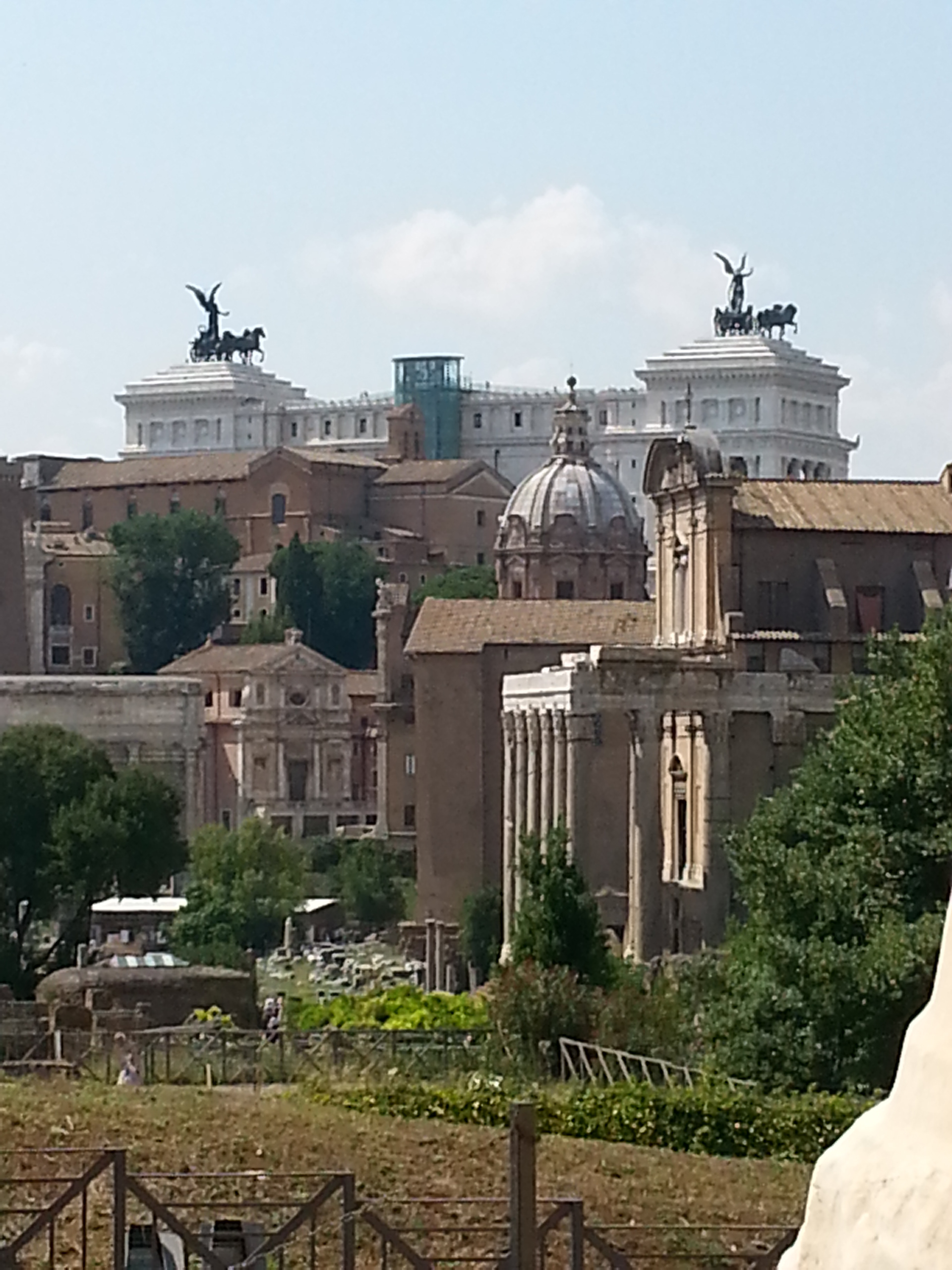 View from the forum of the war memorial monument in Rome. A gigantic building that screams power. It is called Vittorio Emanuele II monument and it was built in honor of the first world war. 
