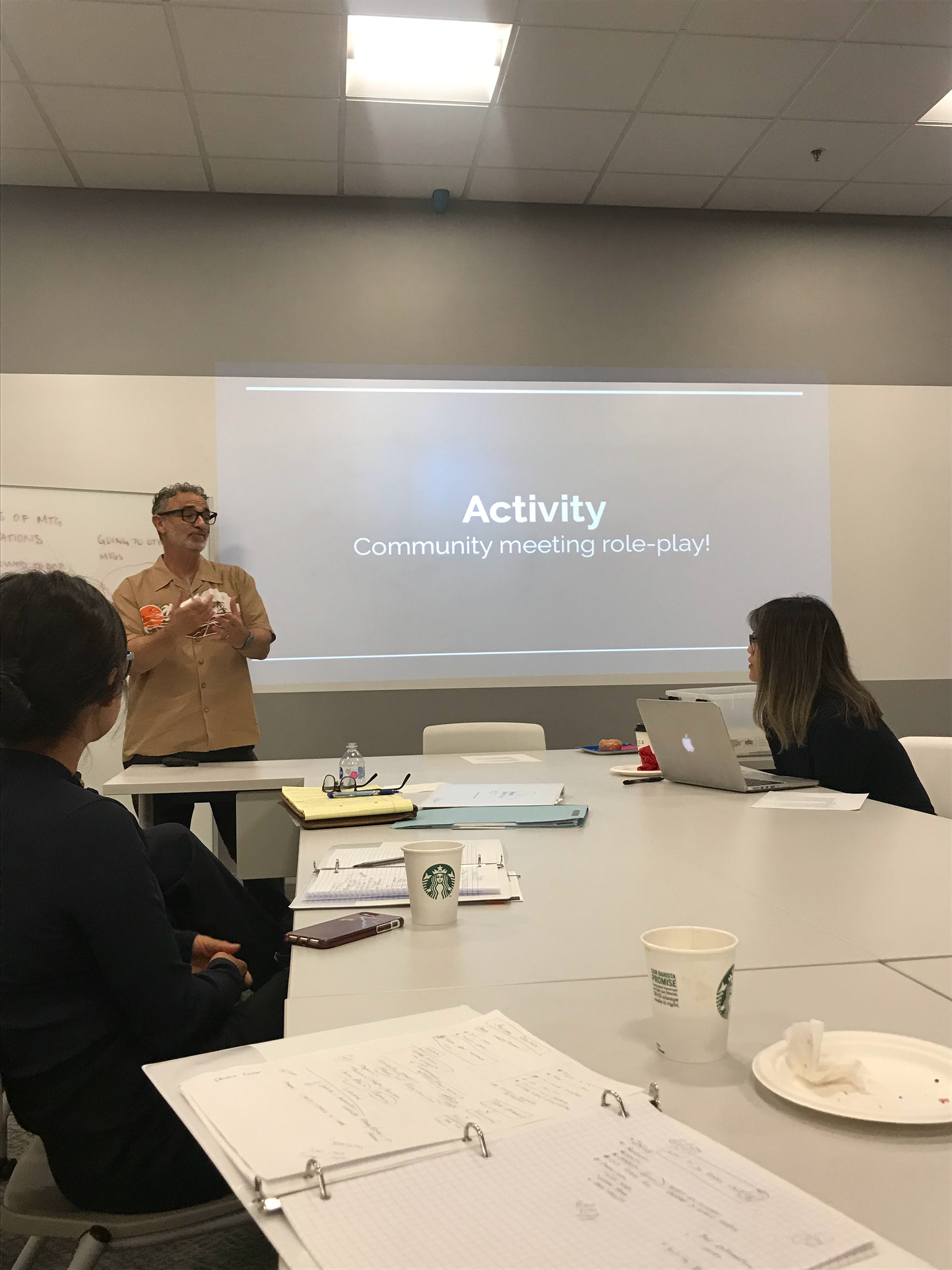 Participants complete a mock community meeting at their fourth and final training