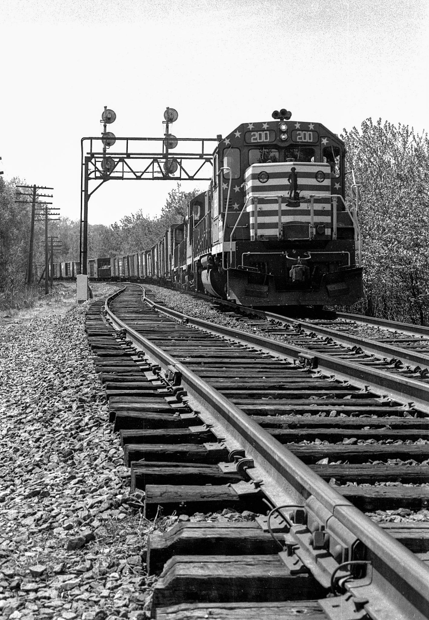 Eastbound B&M freight headed by bicentennial unit GP-38 #200, at Willows (east) Mass, 1976.