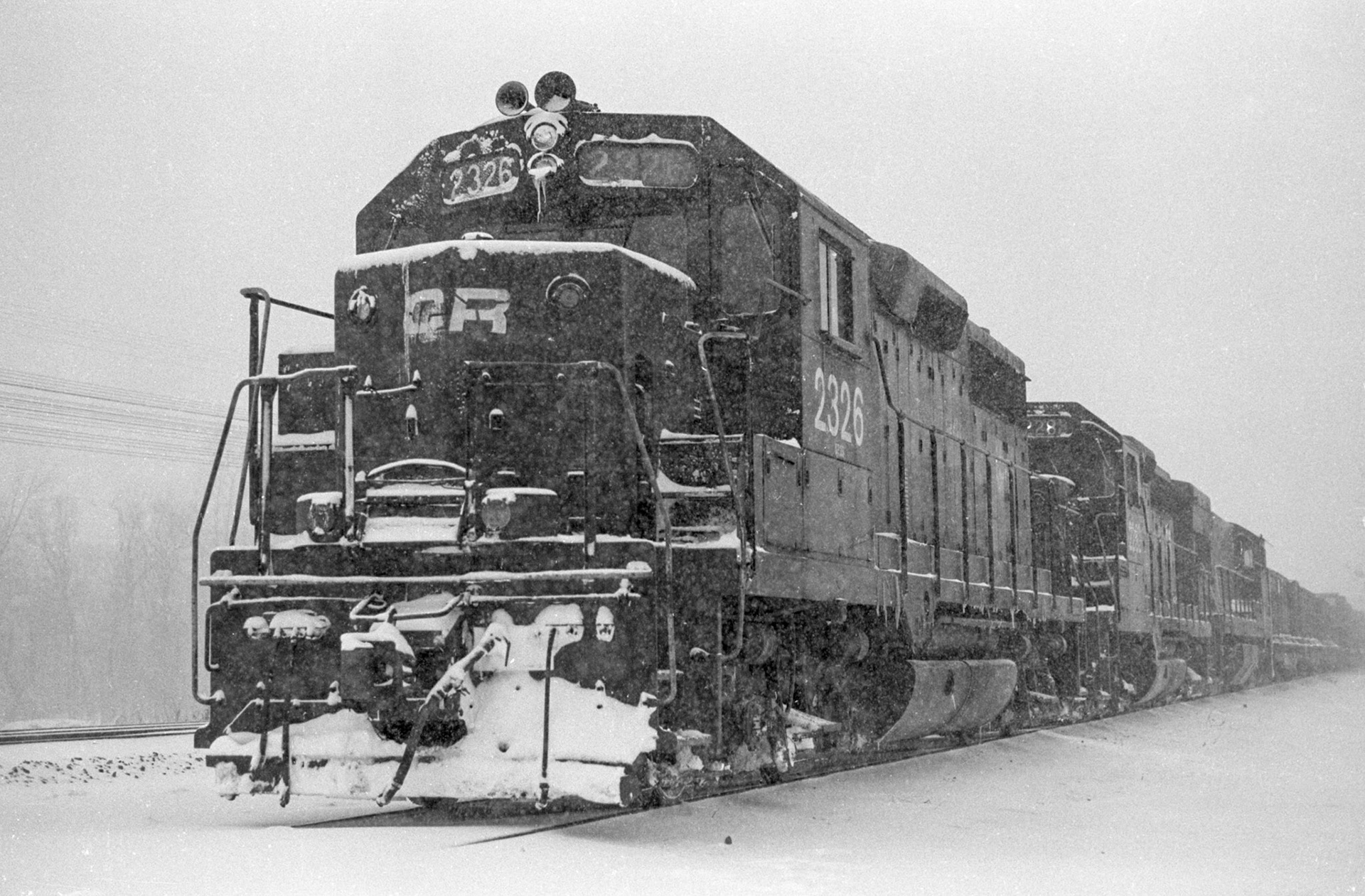 Eastbound Conrail freight dead on hours sits on the controlled siding at Savannah, NY, winter, 1979.