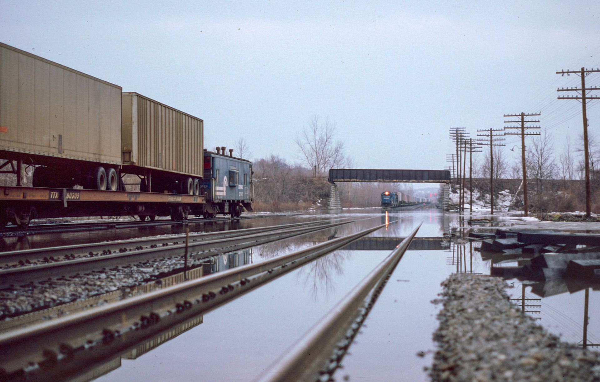 Trains running nose-to-tail through the flooded section under the Sodus branch.