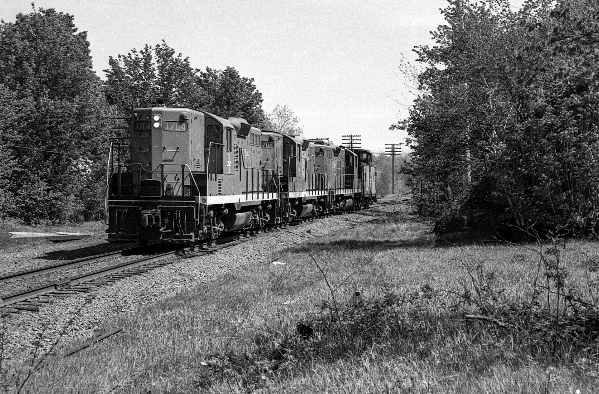 B&M 1704, 1702 and 1738 lead a very short westbound AP-1 through West Acton, MA, 1976