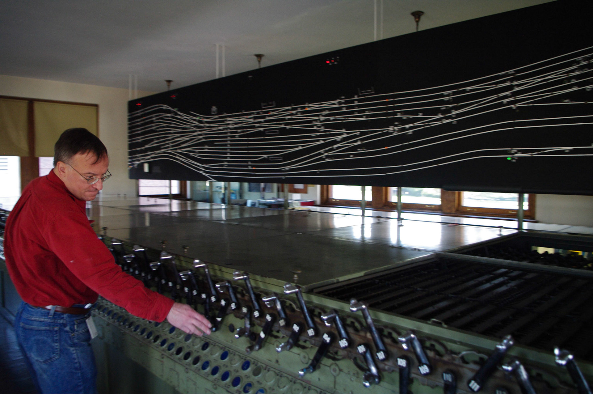 The model board lights up as computer-simulated trains move through the plant