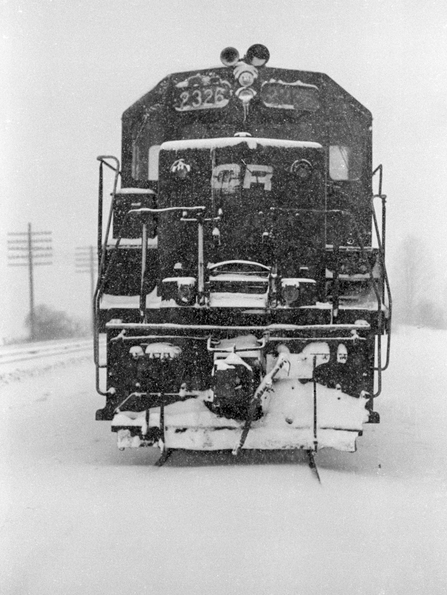 Eastbound Conrail freight dead on hours sits on the controlled siding at Savannah, NY, winter, 1979.