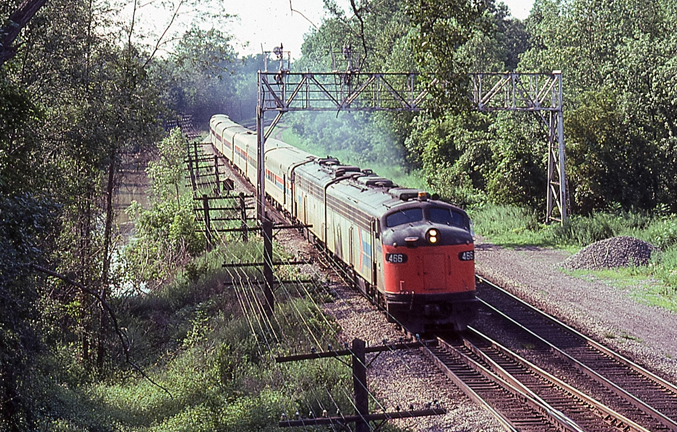Amtrak eastbound train 64 at CP15, Newark, N.Y. on Aug. 12, 1977.