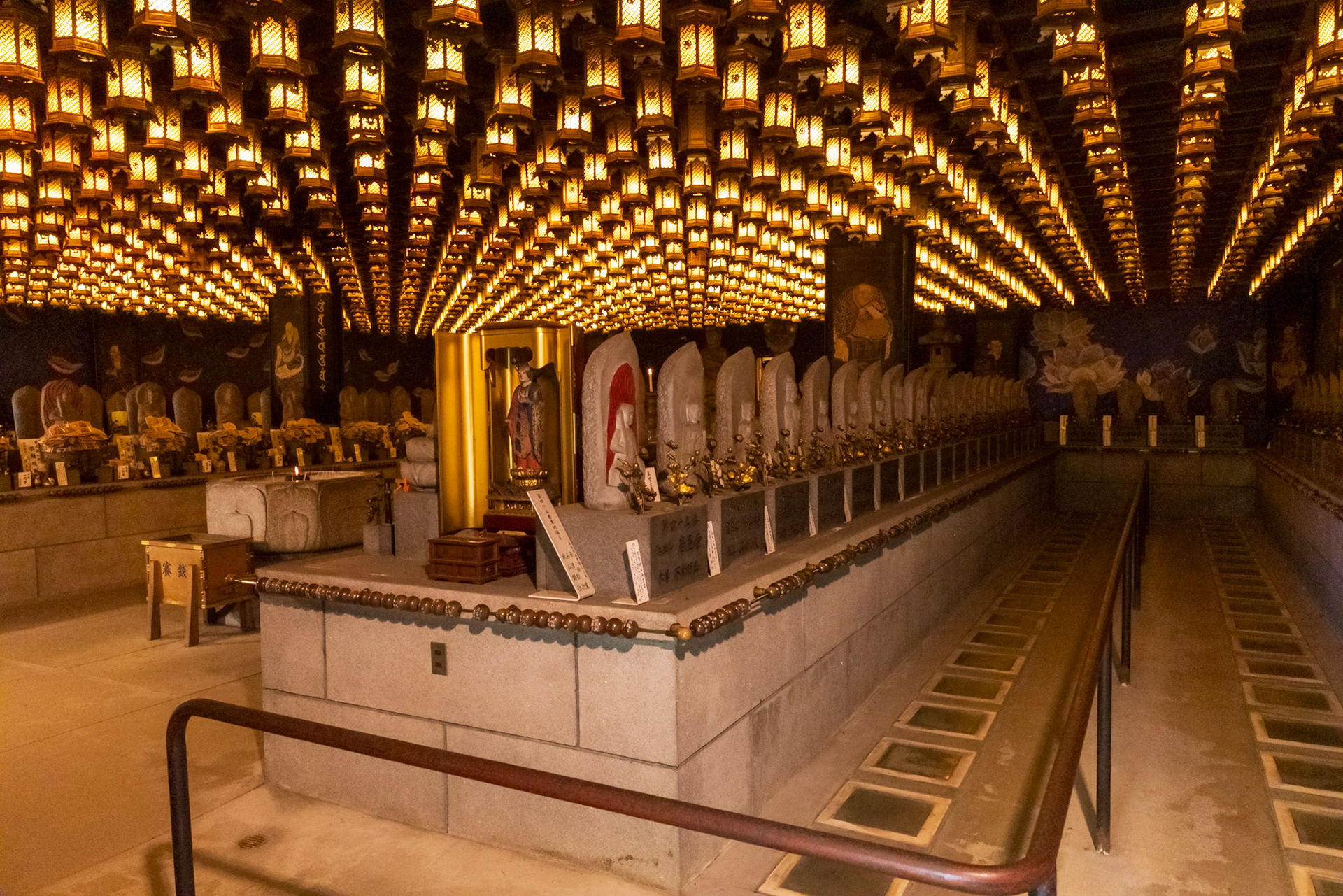 The Henjokutsu Cave: Tucked away on the grounds is a dim, atmospheric subterranean cave illuminated entirely by the soft glow of hanging lanterns. It houses standard icons from all 88 temples of the famous Shikoku Pilgrimage route, allowing visitors to symbolically complete the entire multi-week pilgrimage by walking across a path of sand collected from each sacred site.