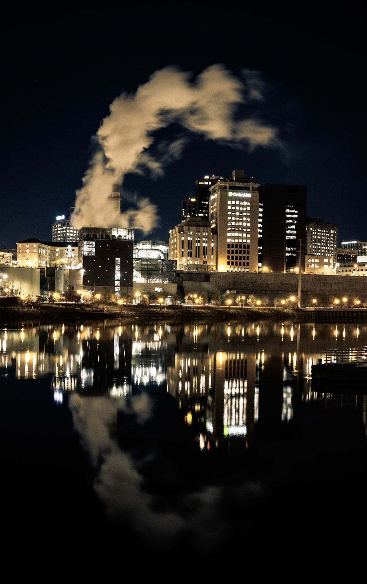 The heavey machines of the busy city at work on the other side of the river, while I sit in silence and watch the wind blow on this side of the river.