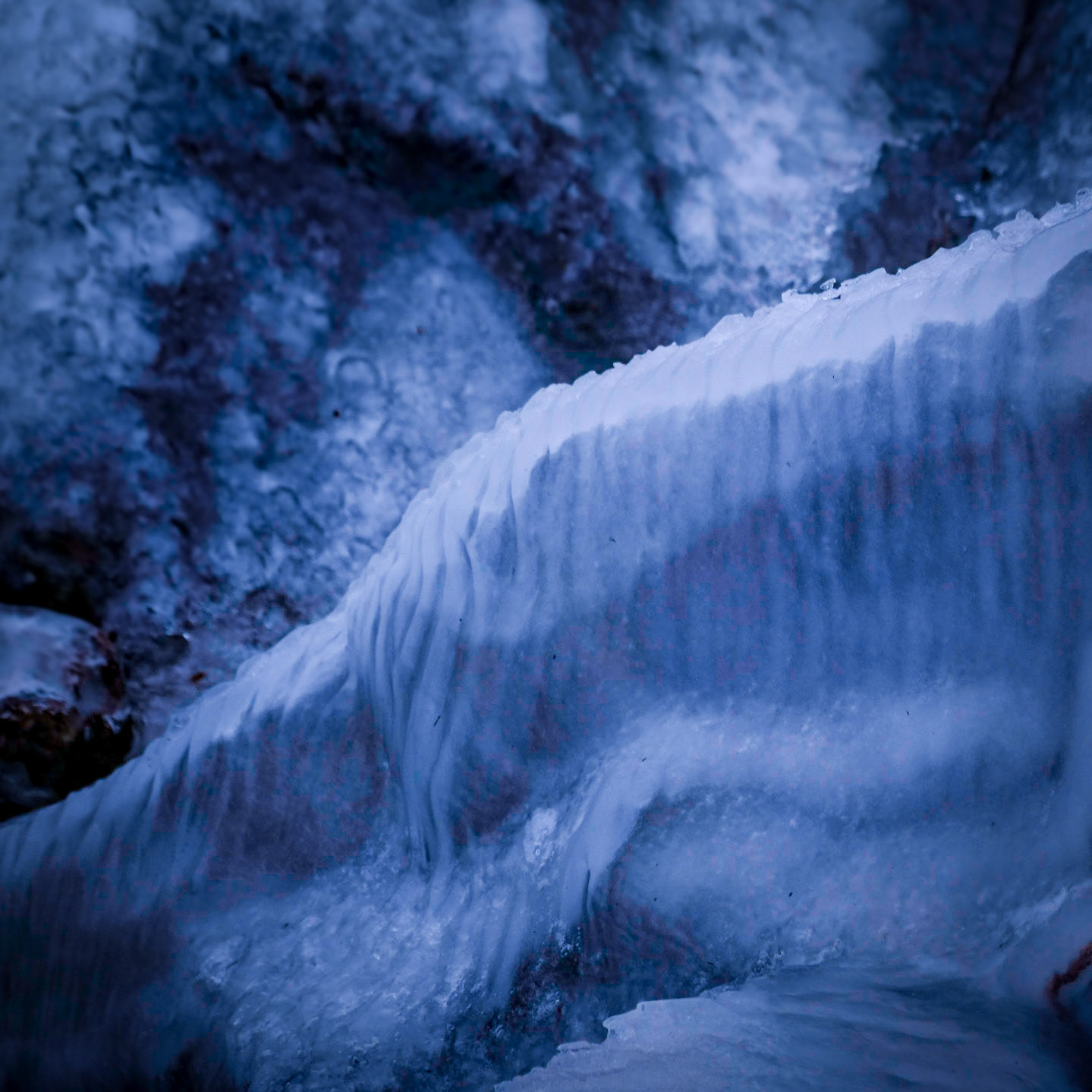 The Soft Blanket of Ice Cover the Firm Rocky Shore.