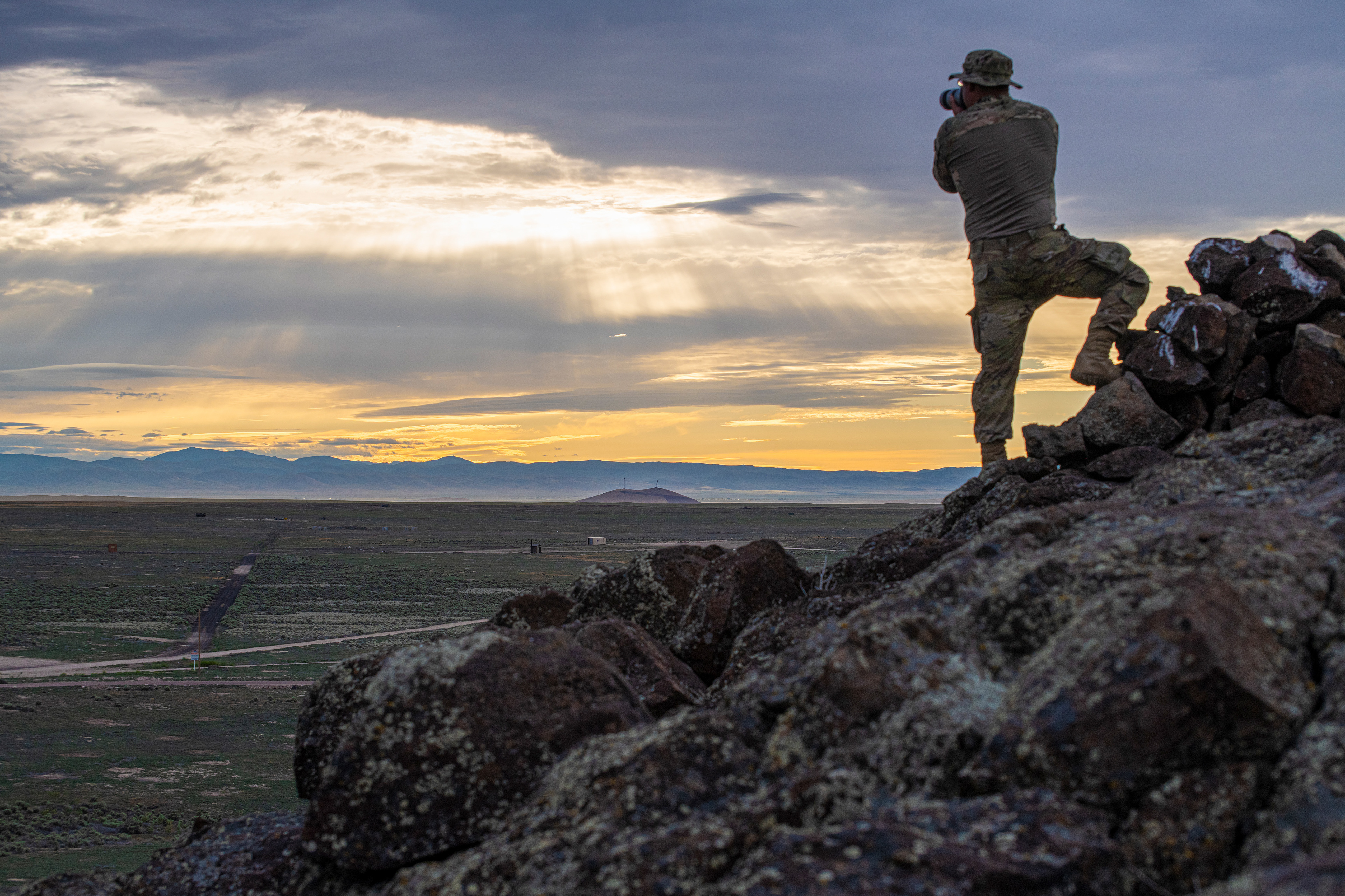 U.S. Soldier taking a photograph of a sunset