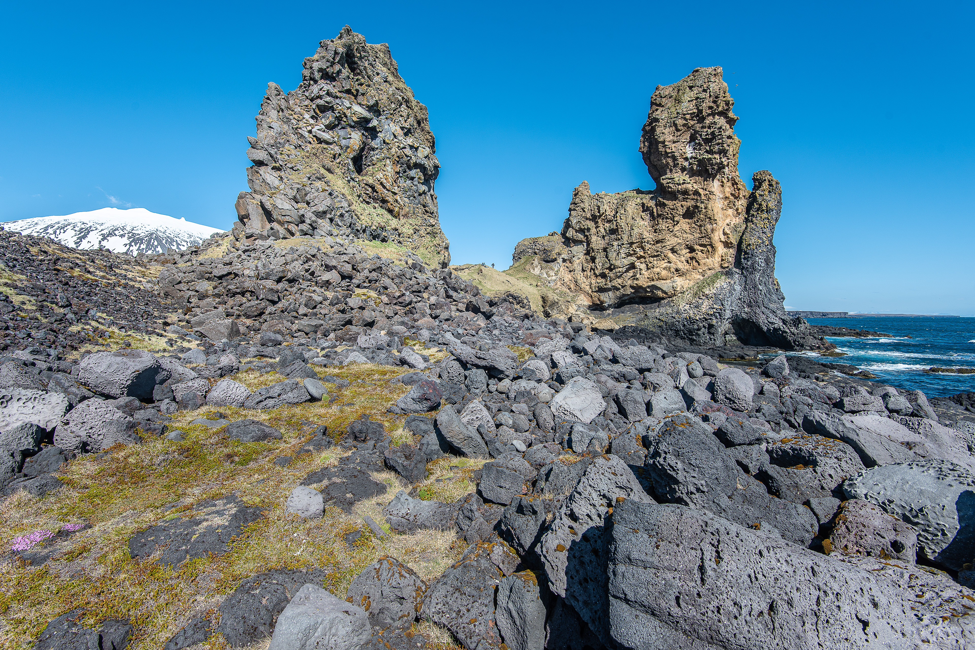Lóndrangar sea stacks and pillars with two people in the middle