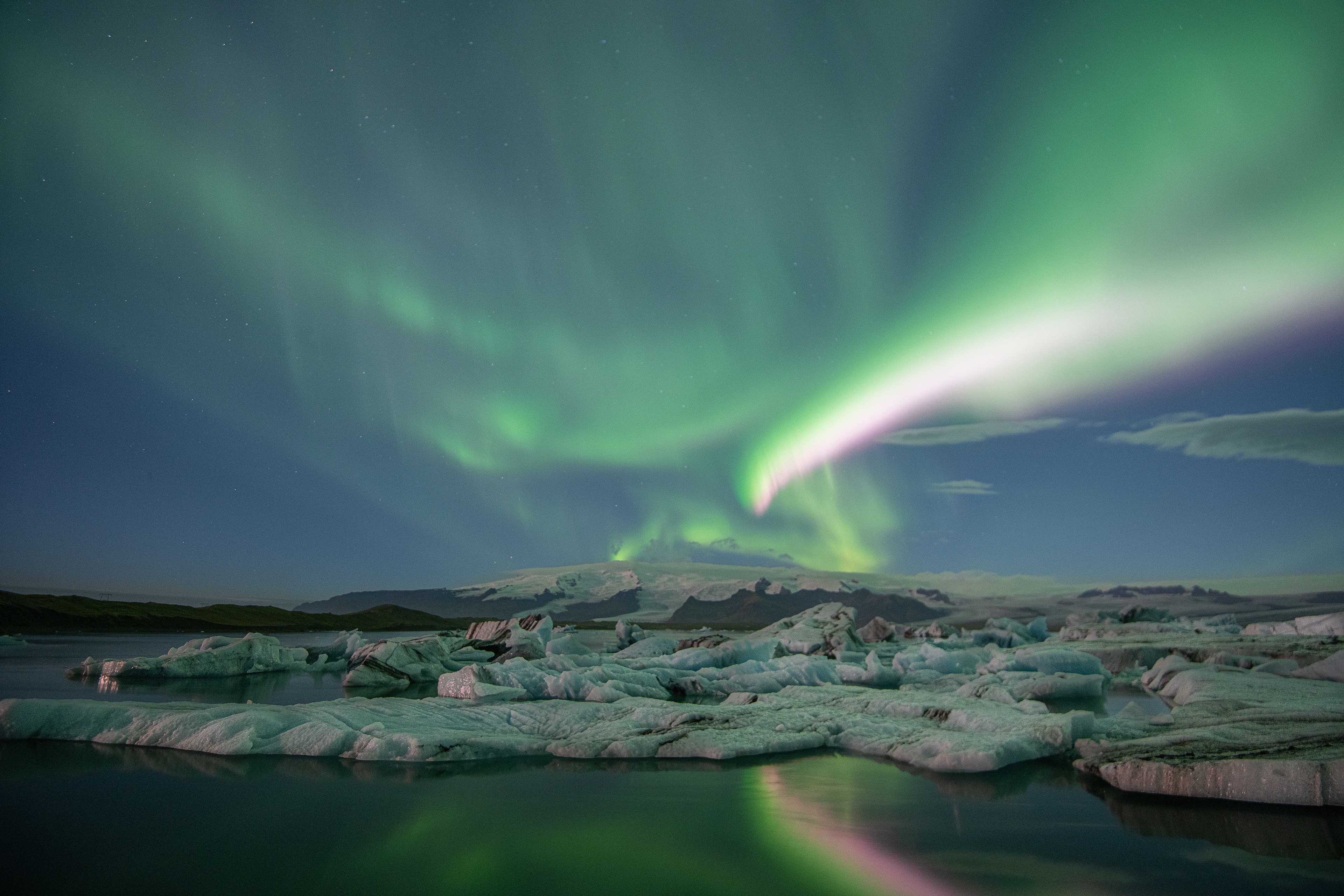 September evening as Aurora Borealis lights up the sky and reflects in the lagoon