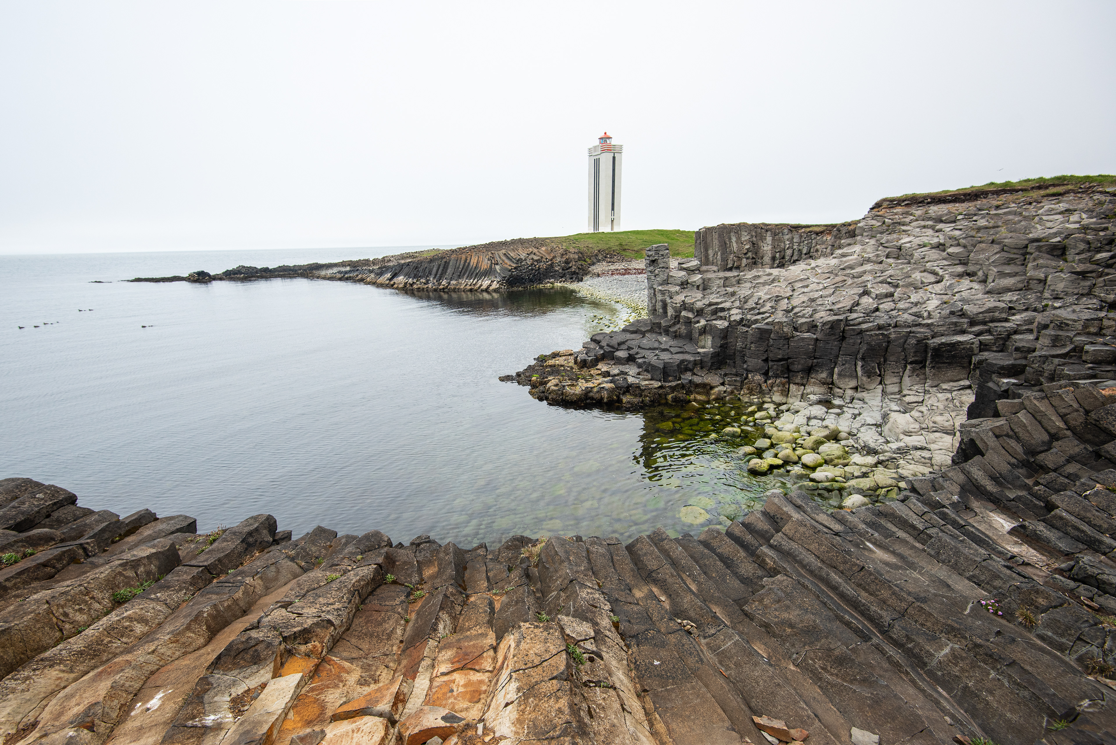 The basalt column stacks spread out on the shoreline in a beautiful formation