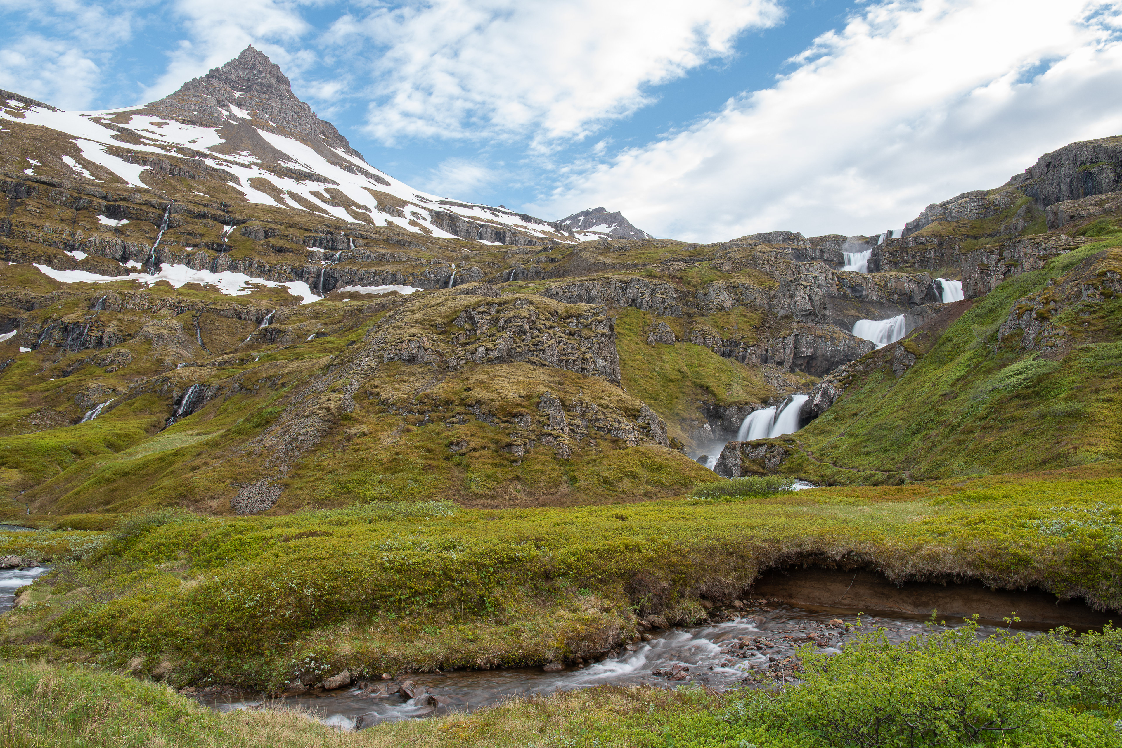 The best angle to take a photo of Klifbrekkufossar is from the area around the parking lot