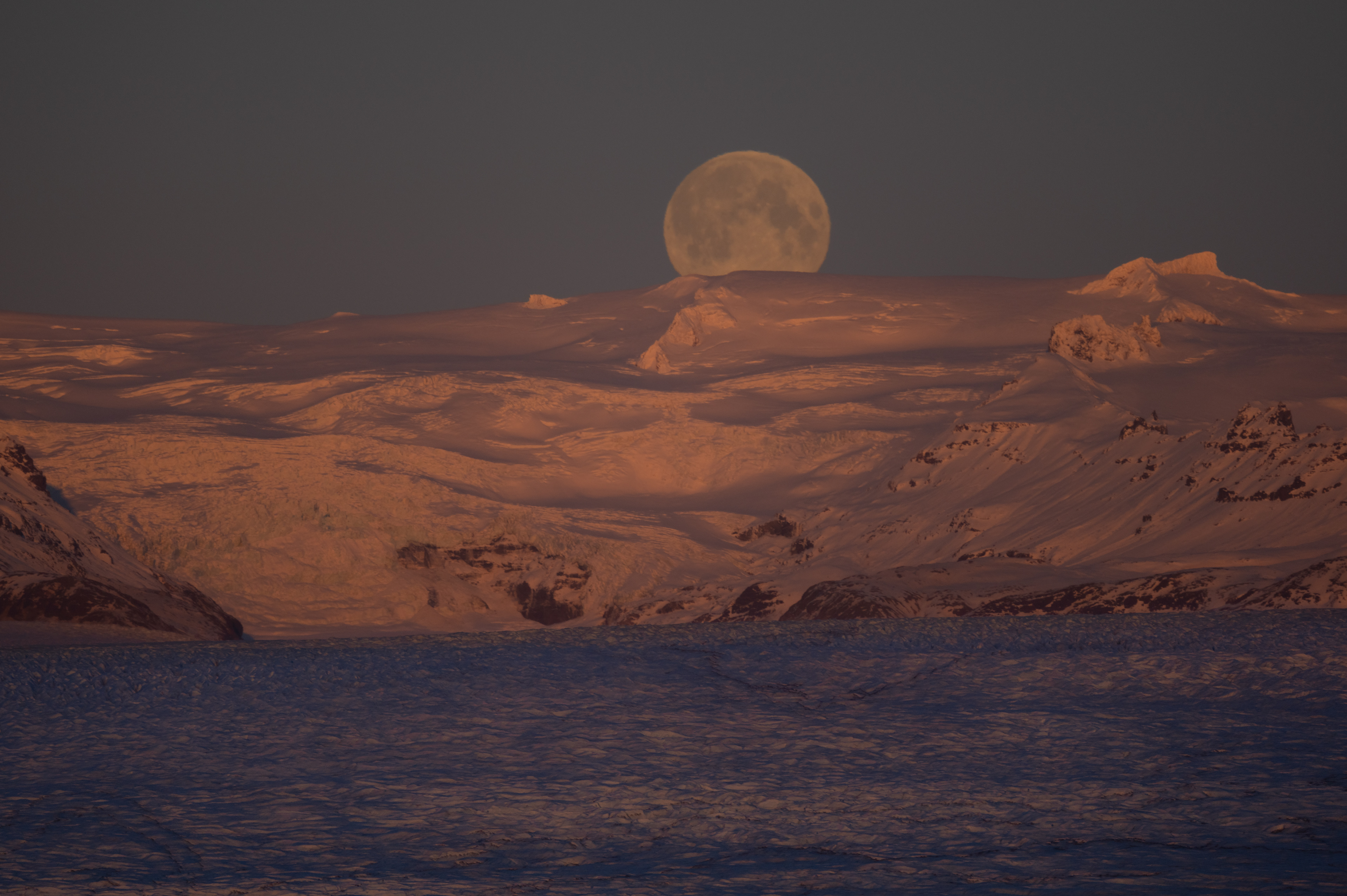 The moon escaping behind Breiðamerkurjjökull glacier by Jökulsárlón