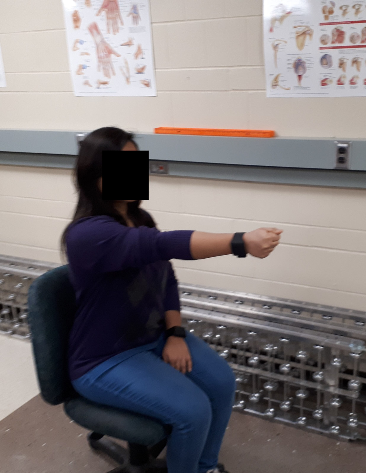 Two laboratory images showing fatigue assessment methods: a participant wearing an Empatica E4 wristband for motion-based tremor measurement, heart rate, and heart rate variability, and a participant performing a Psychomotor Vigilance Test to assess alertness.