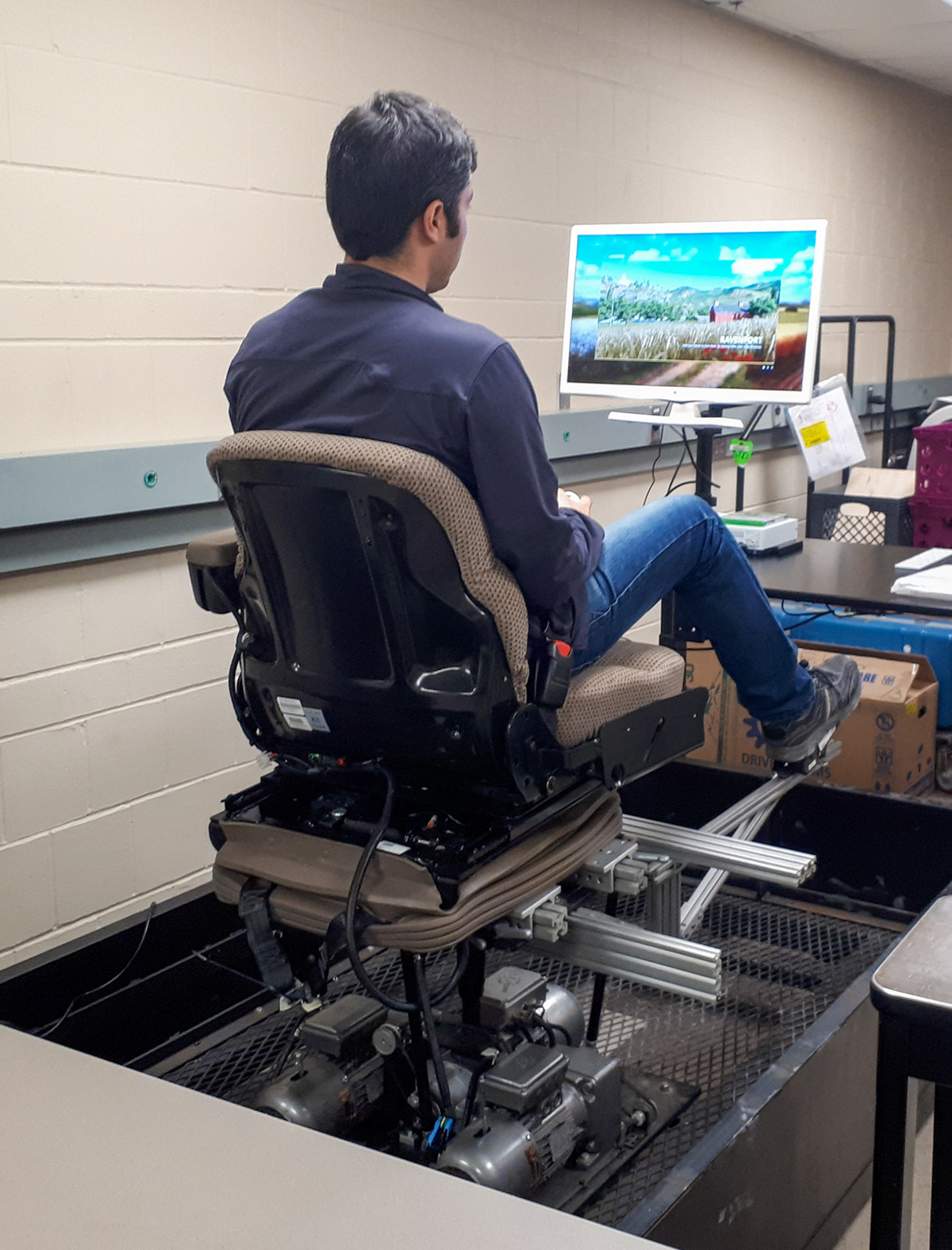 Research participant seated on an industrial seating system in a laboratory environment during a controlled evaluation setup.