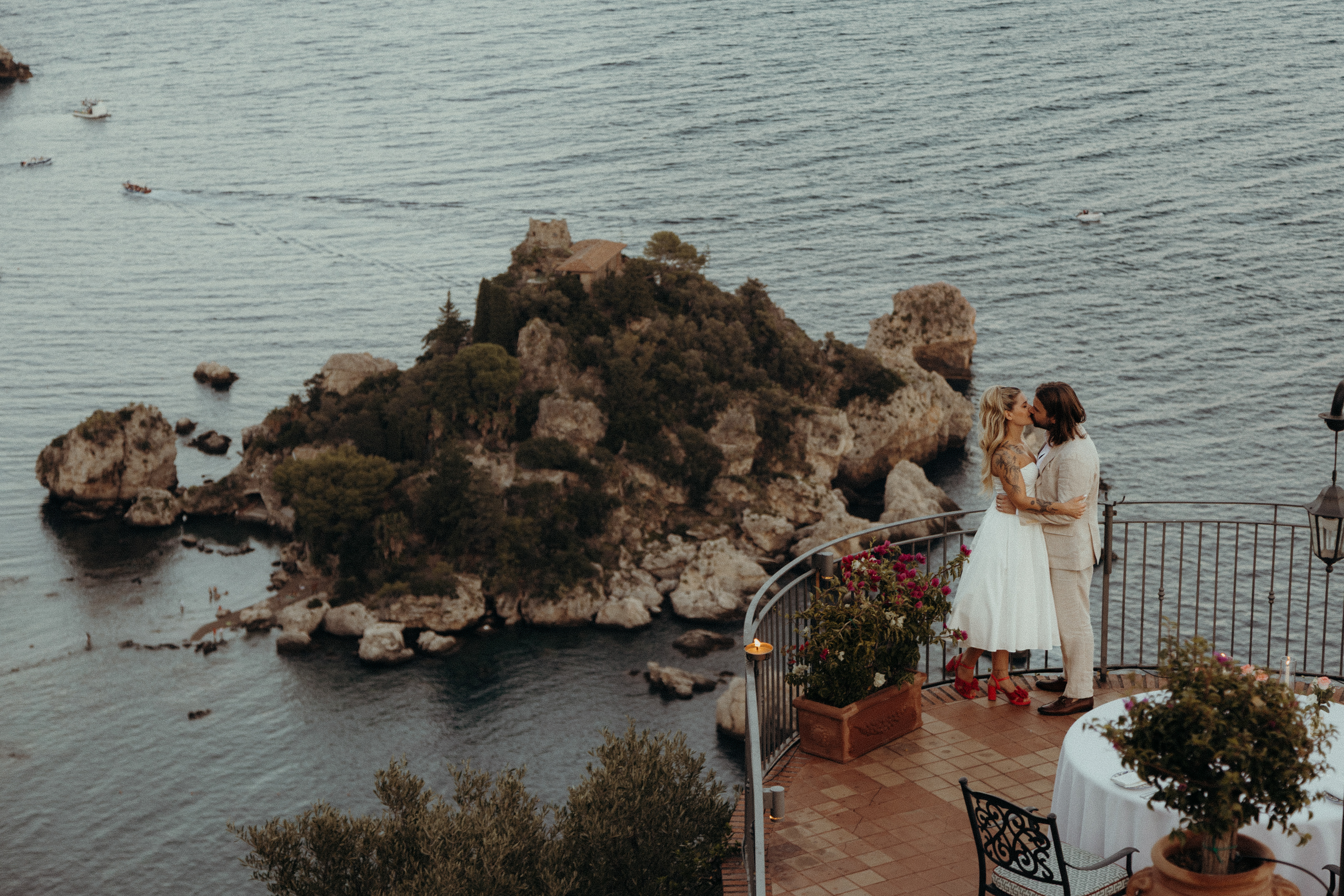 Couple embracing during an intimate elopement in Sicily with Mount Etna landscape in the background.