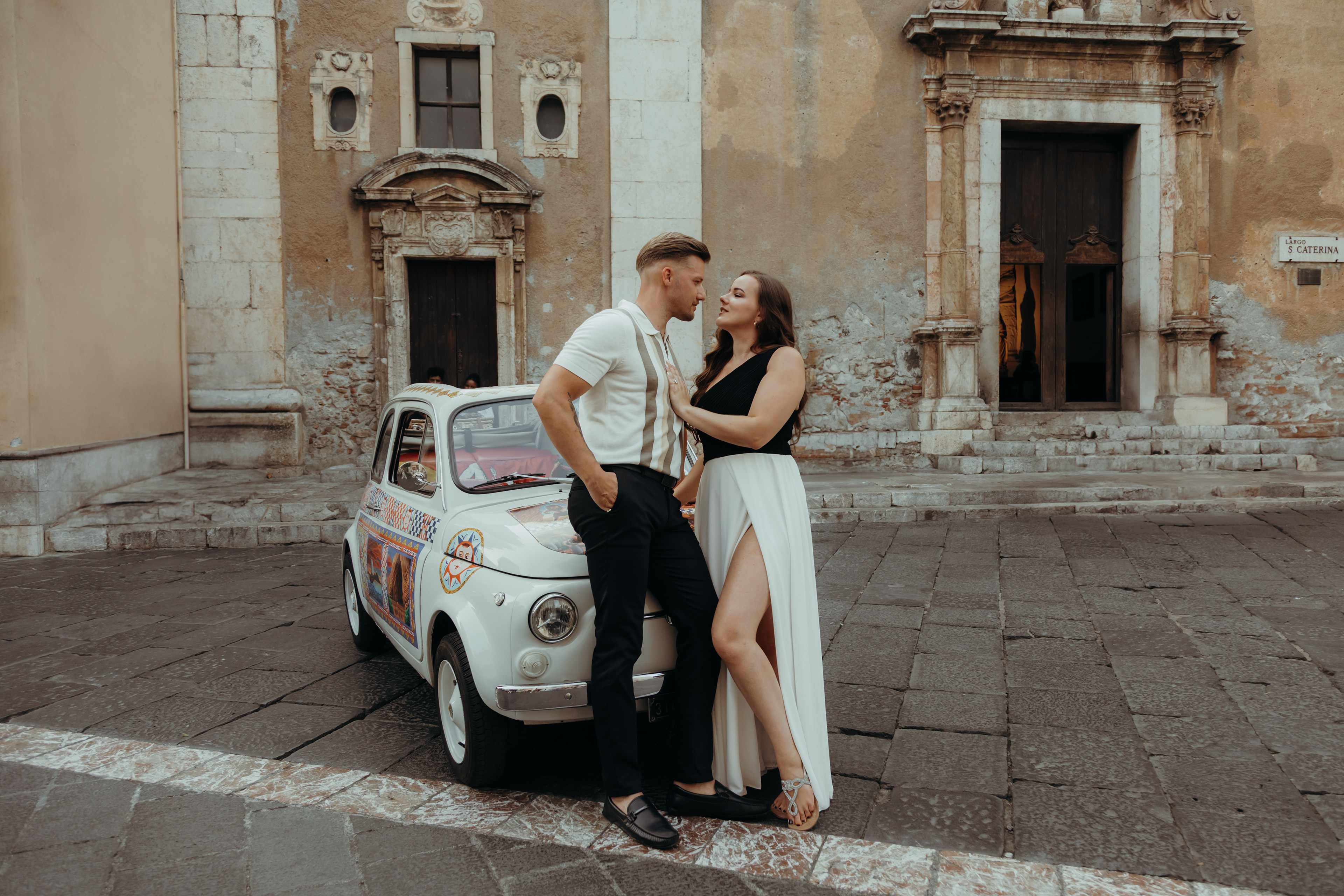 Surprise marriage proposal in Taormina, Sicily with emotional reaction overlooking Isola Bella.