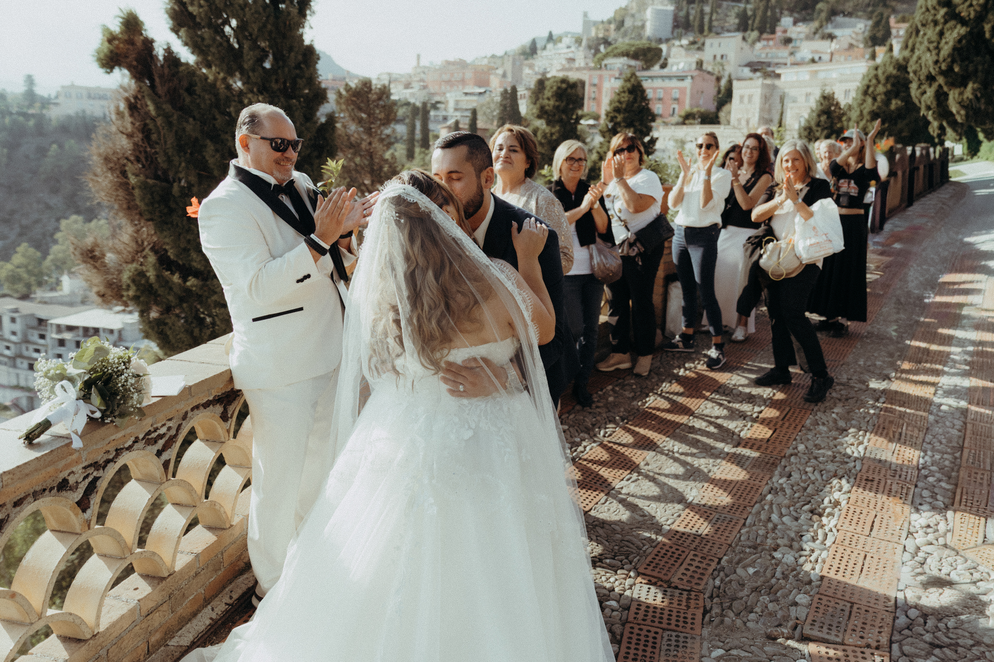 Bride and groom celebrating their destination wedding in Taormina, Sicily with sea views and romantic Mediterranean atmosphere.