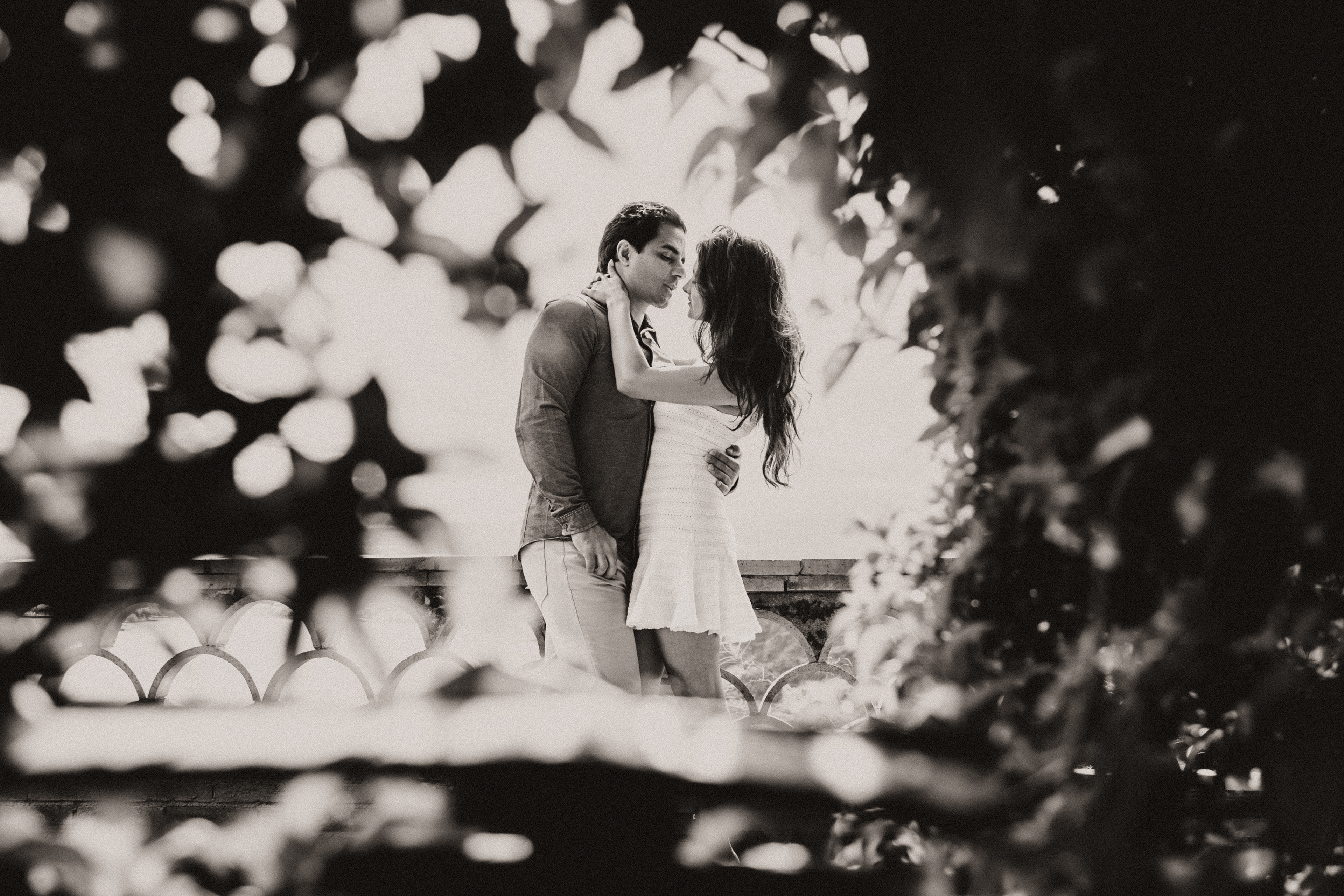 Romantic couple photoshoot in Sicily at sunset with Mediterranean coastline in Taormina.